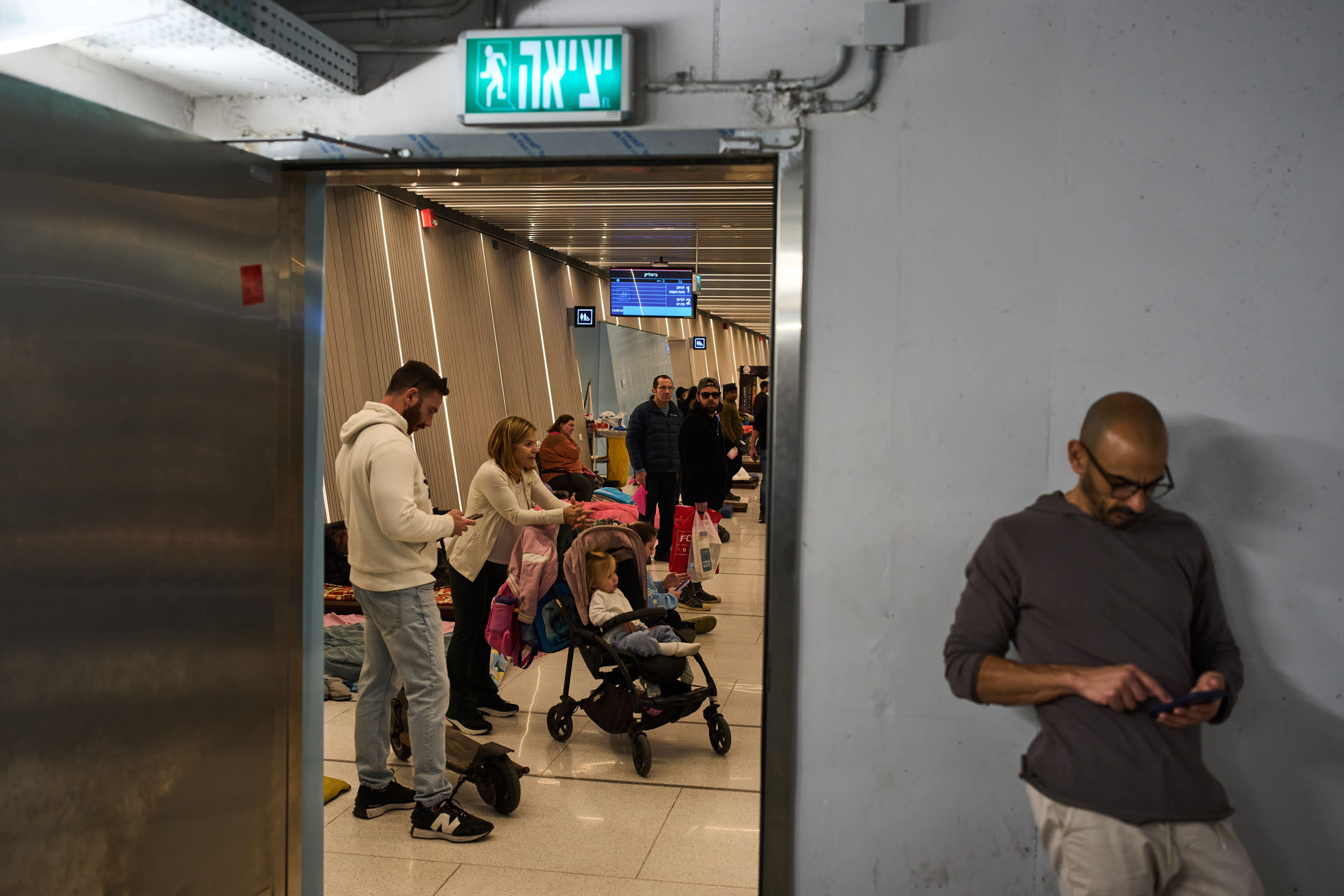 Israelis take shelter in an underground metro station