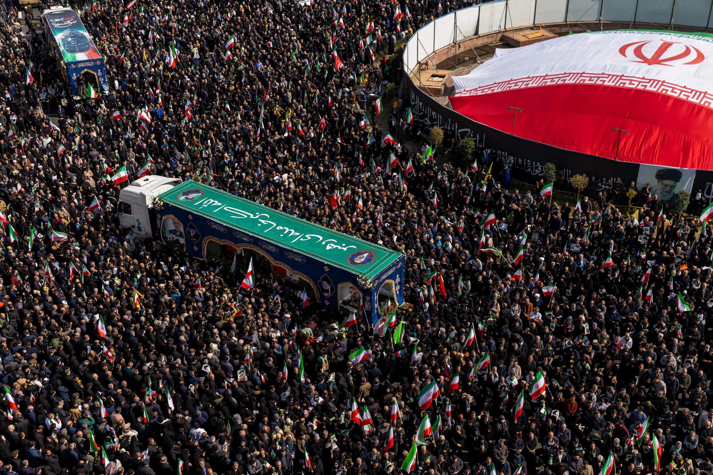 Large crowds gather during a joint funeral held for Ali Larijani, Secretary of Iran's Supreme National Security Council, Basij commander Major General Gholam Soleimani, and 84 sailors from the Iranian Navy frigate IRIS Dena, on March 18, 2026 in Tehran.