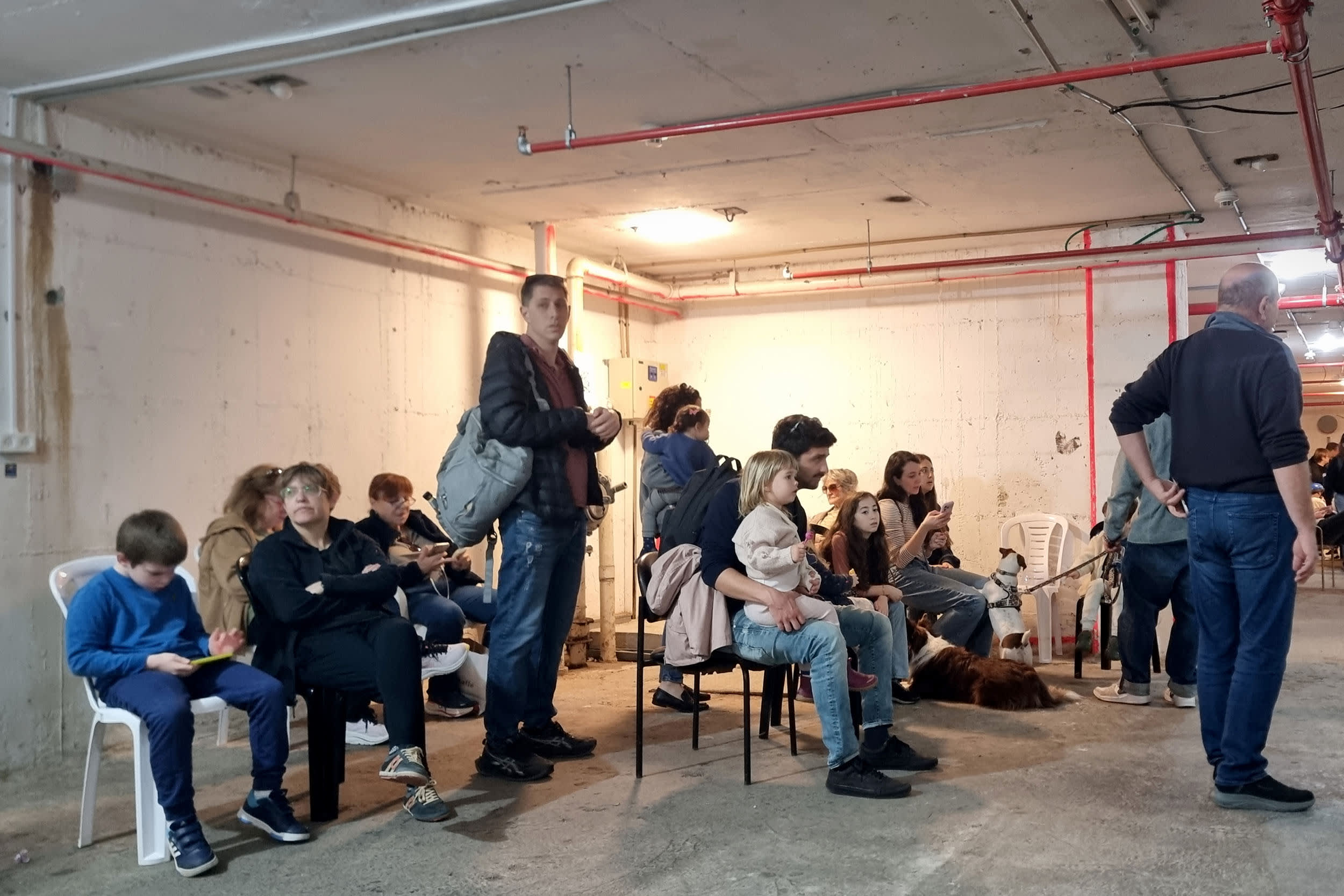 Israelis take cover in a public bomb shelter during an Iranian missile attack on March 20, 2026 in Tel Aviv.