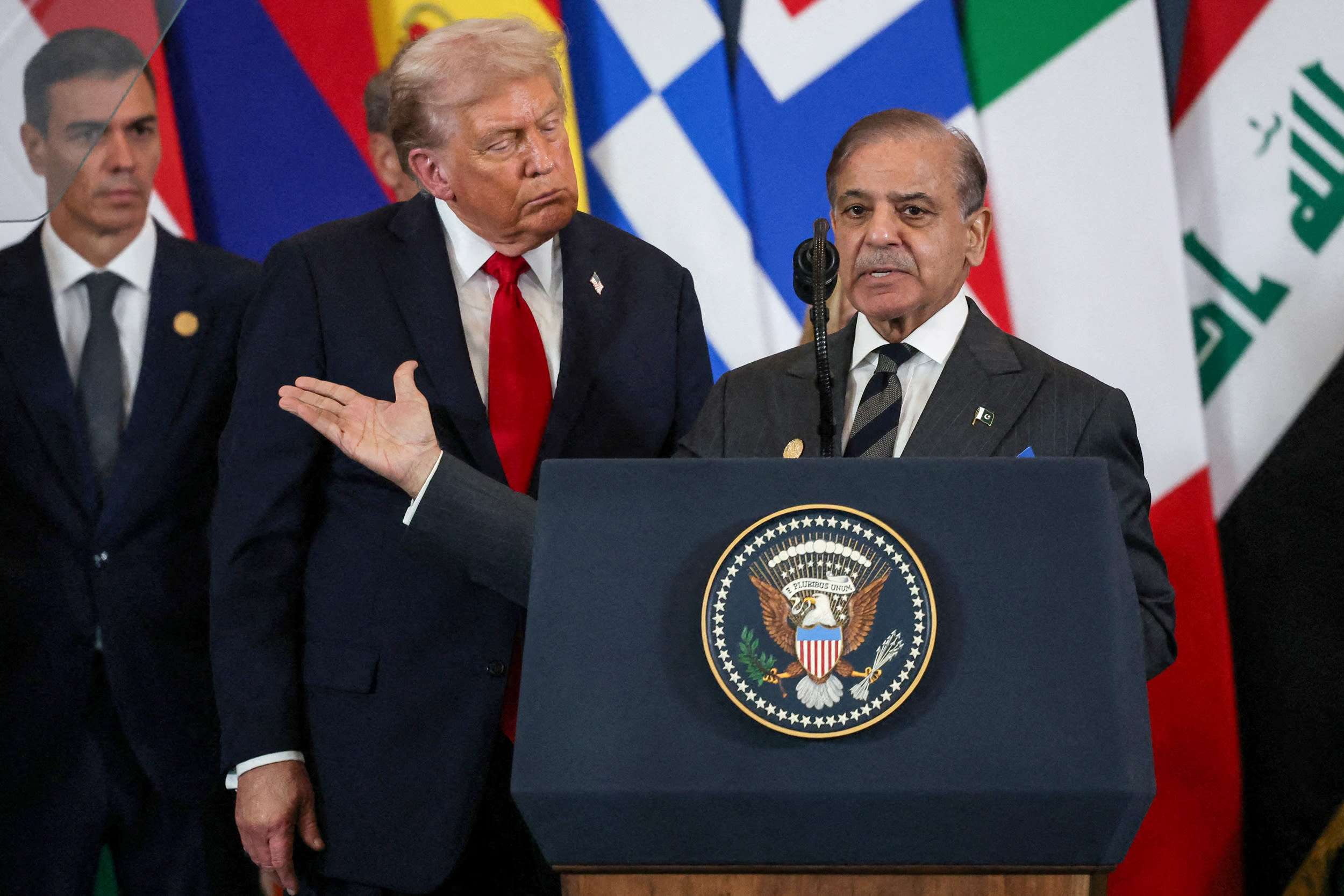 Pakistani Prime Minister Shehbaz Sharif (R) speaks as US President Donald Trump.
