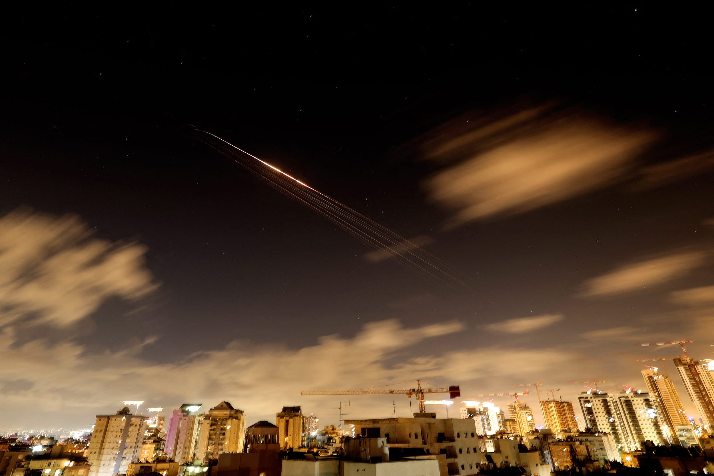 Rocket trails are seen in the sky amid a fresh barrage of Iranian missile attacks above the Israeli coastal city of Netanya.