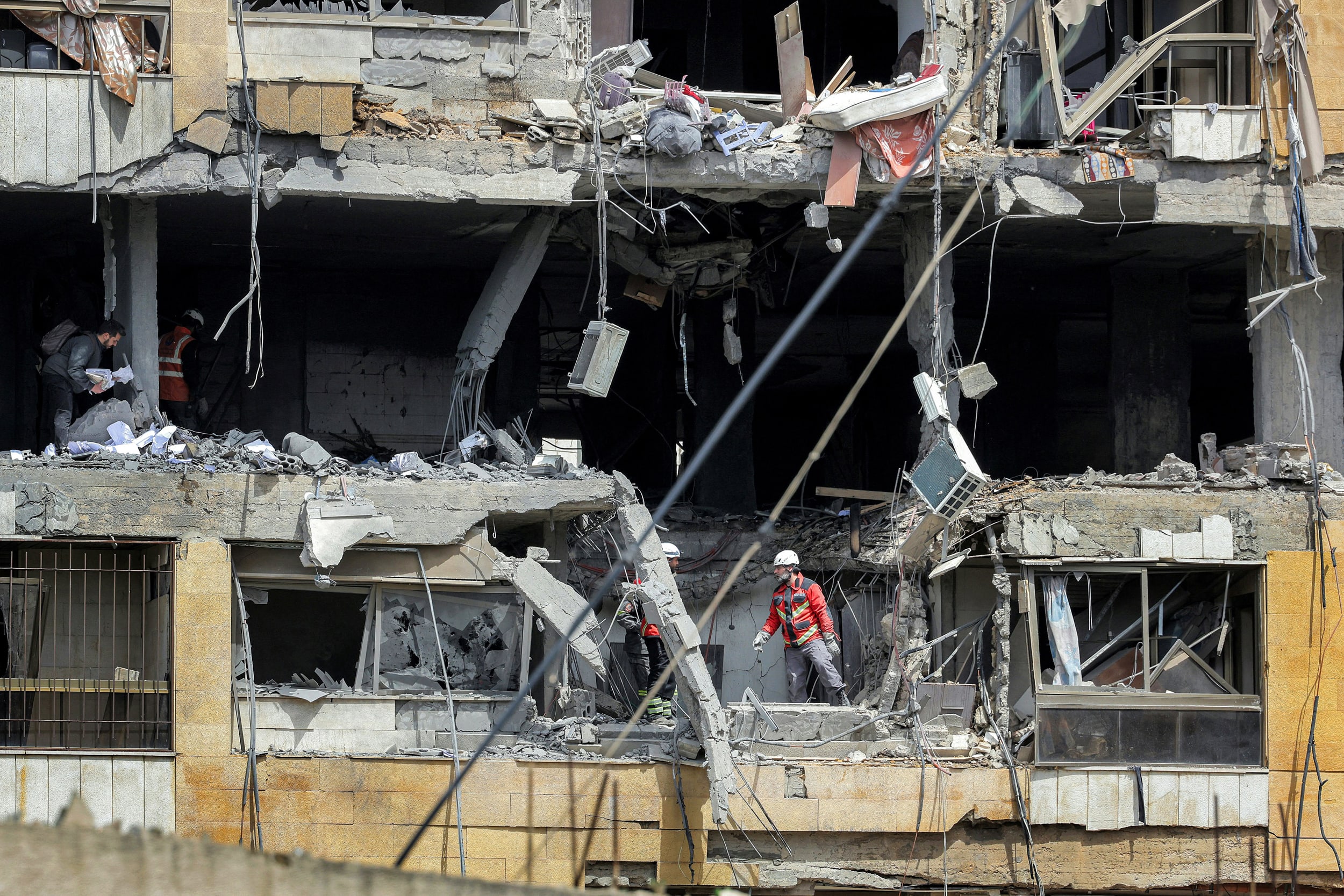 First-responders search a building hit by an Israeli airstrike in Beirut's southern suburbs on March 30, 2026.