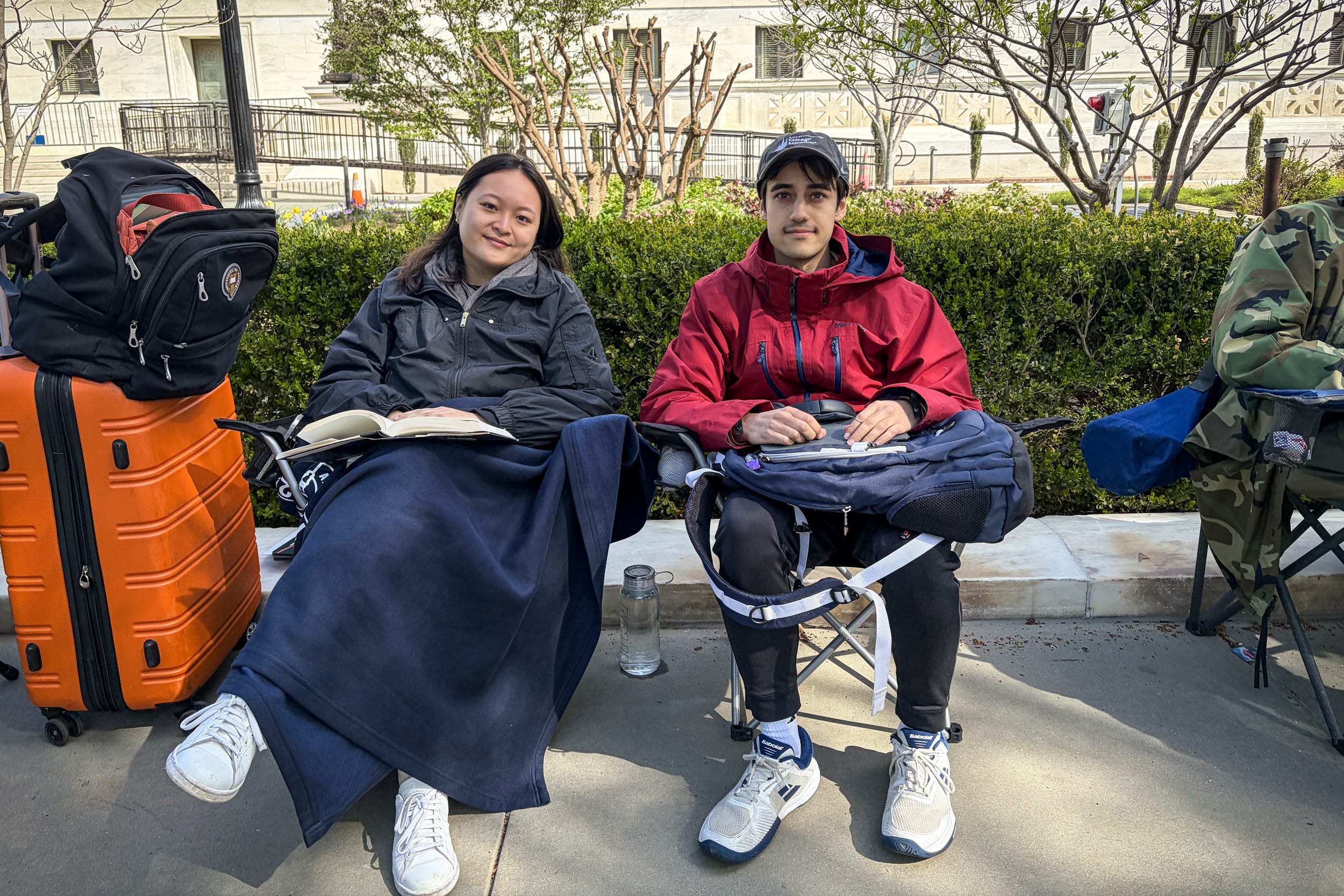 Nina Lin, a special assistant at the American Civil Liberties Union's Ruth Bader Ginsburg Center for Liberty, and her colleague sit in line outside the Supreme Court on March 31, 2026.
