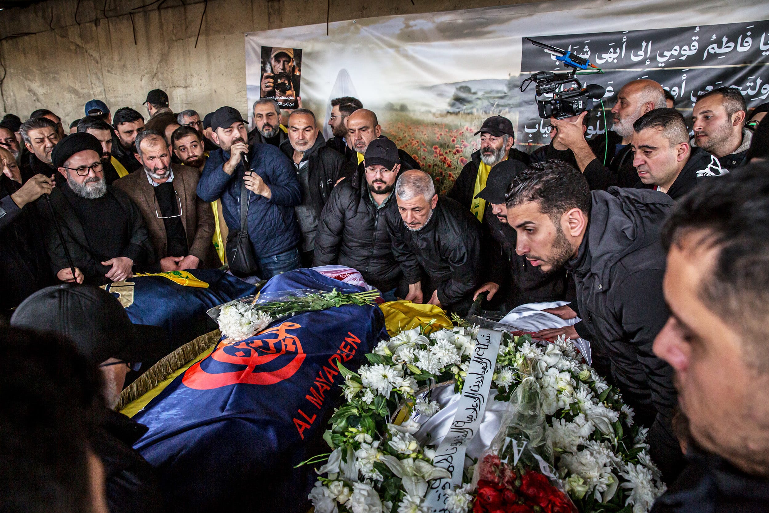 Mourners pray by coffins in Choueifat, south of Beirut,