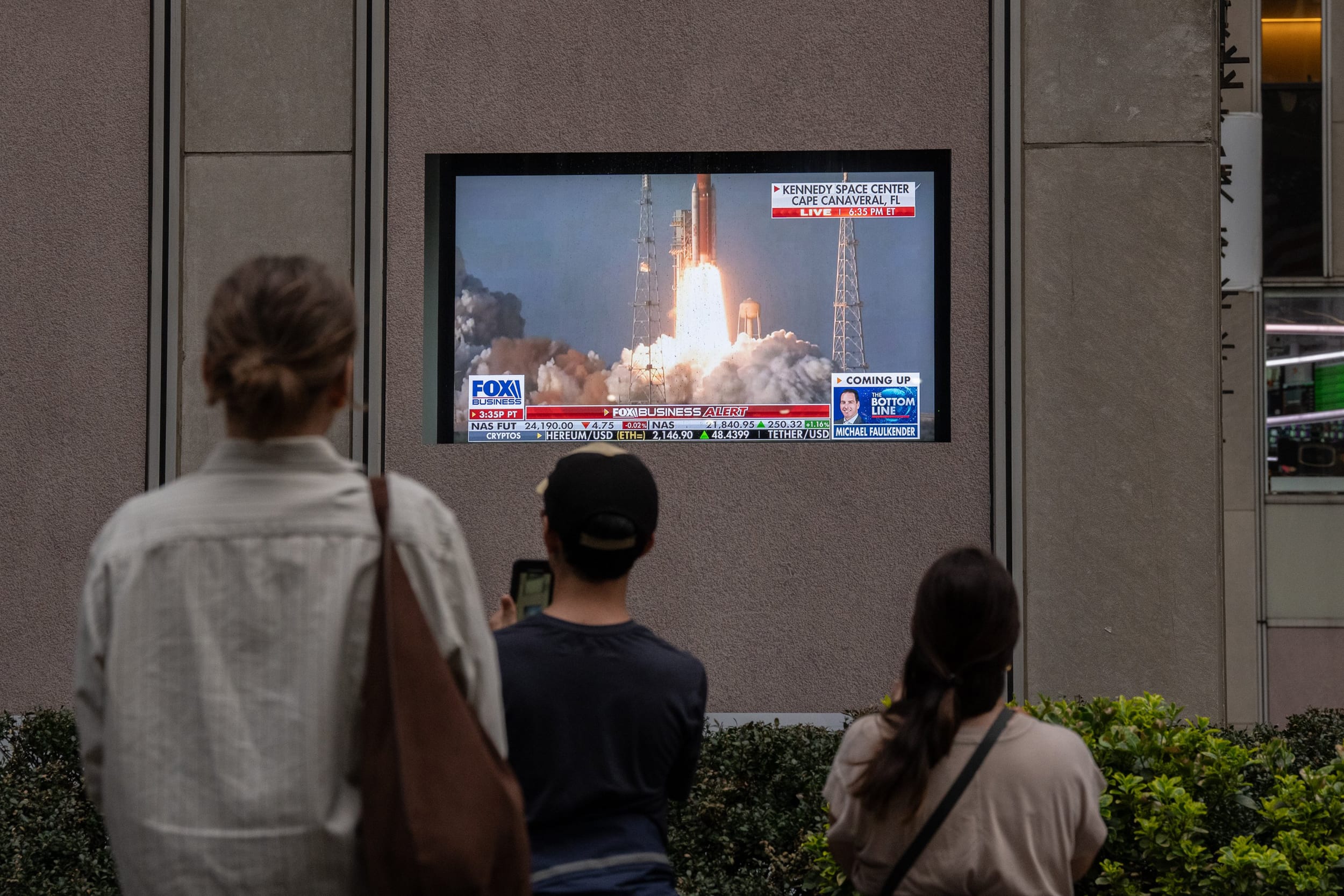 Image: People Watch The Artemis II Moon Mission Launch In Midtown Manhattan