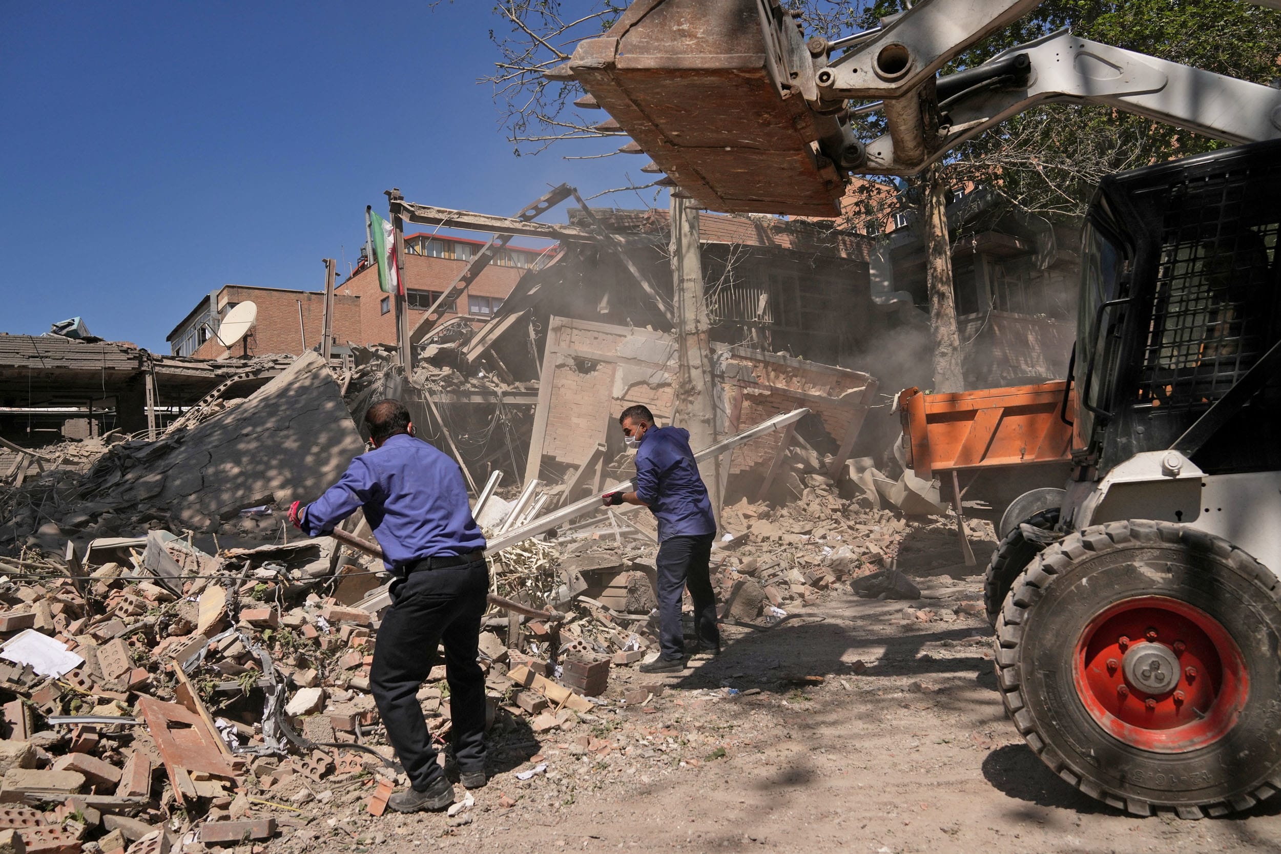 Workers remove debris at Tehran's Sharif University of Technology complex after was hit by a U.S.-Israeli strike.