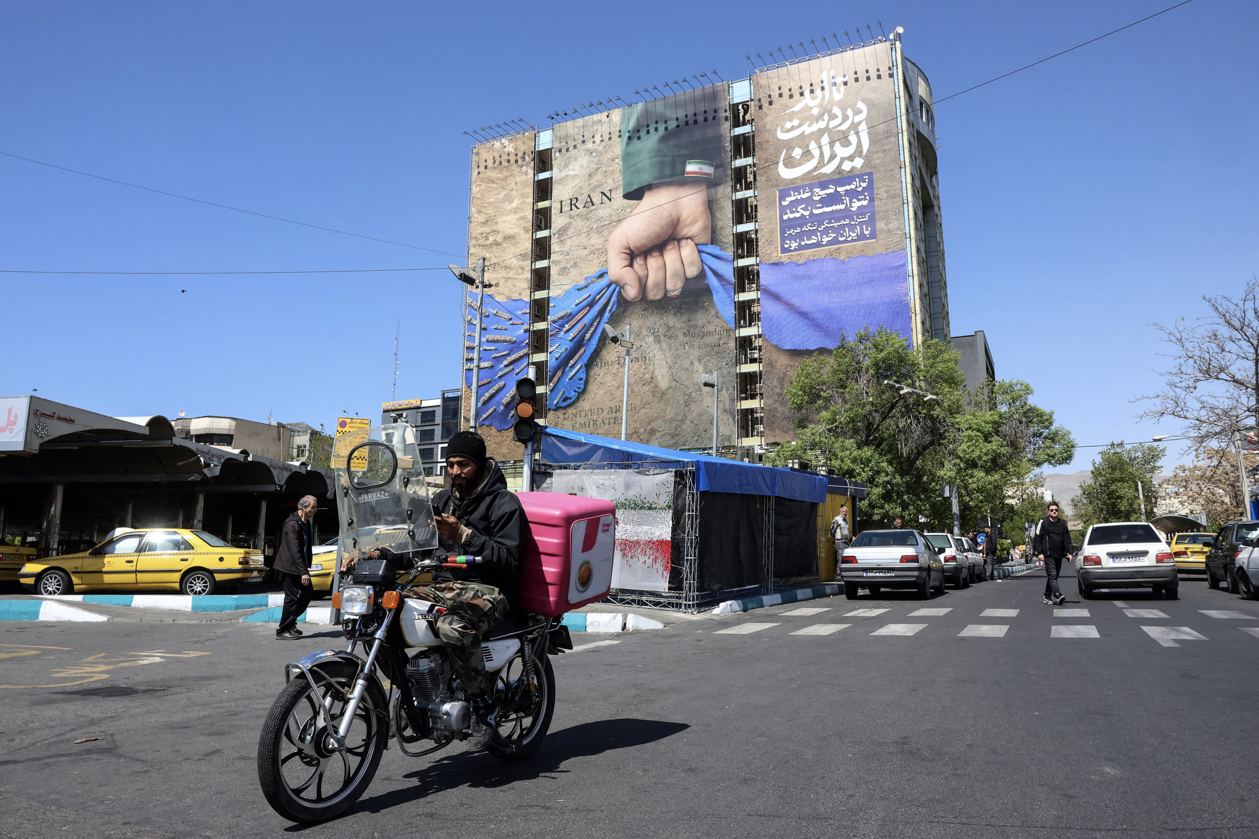 A billboard depicts Iran controlling the Strait of Hormuz in Tehran's Vanak Square on April 15, 2026. 