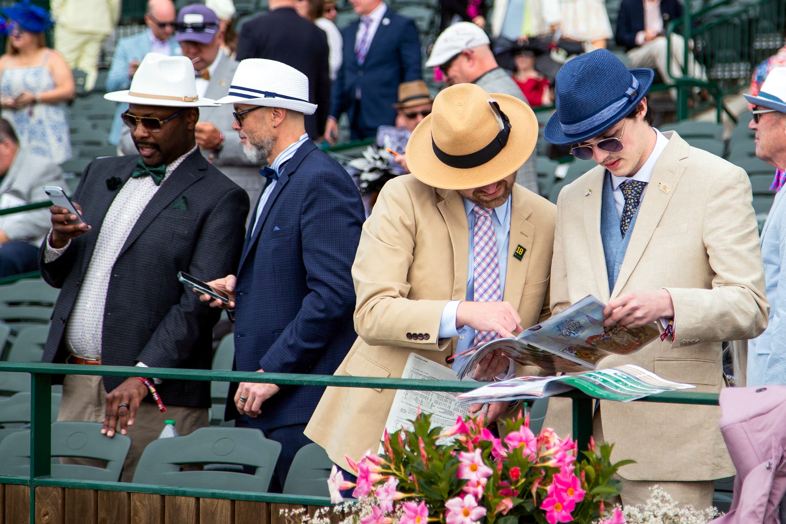Attendees check racing forms of the prep races.