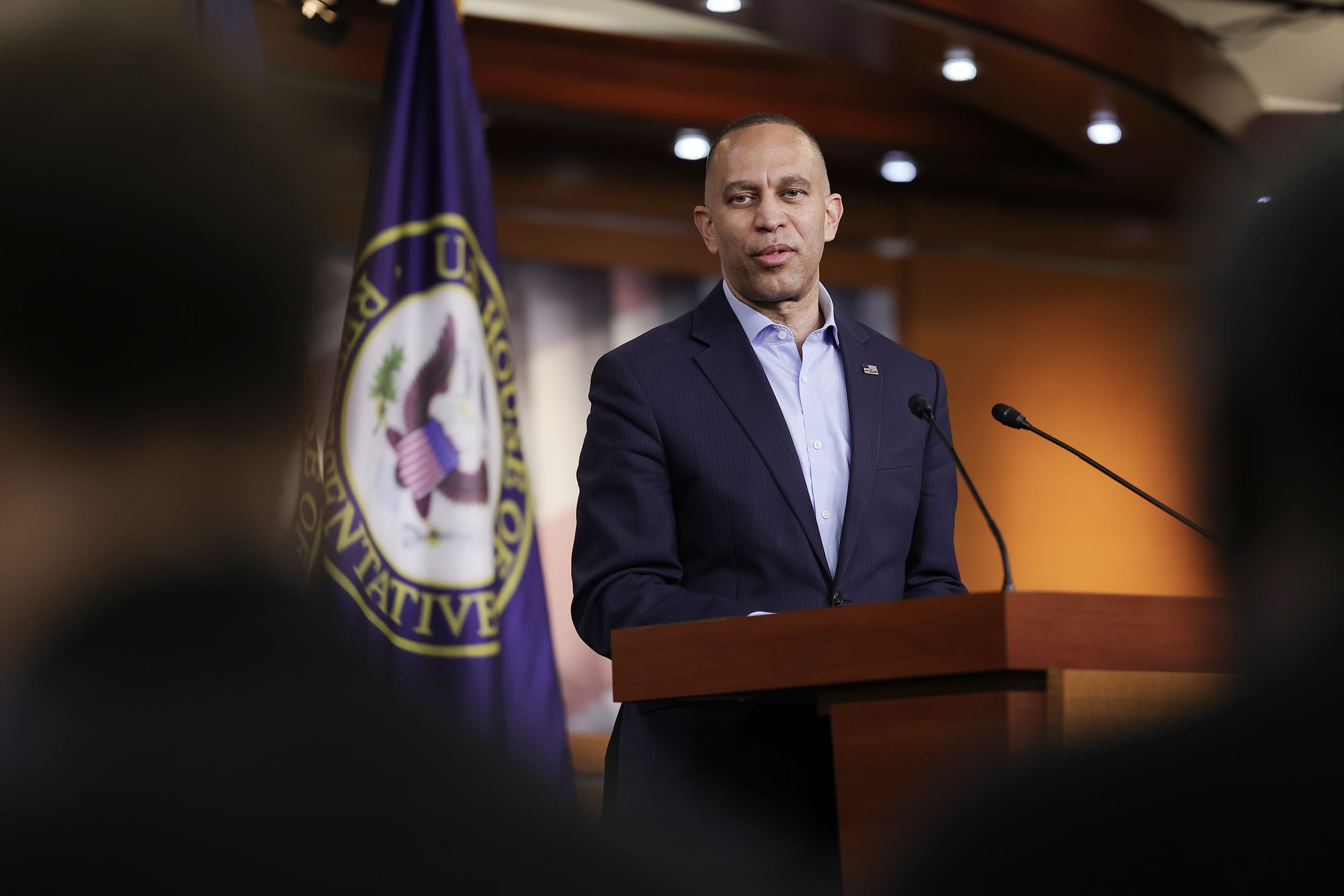 Hakeem Jeffries standing at a lectern in a press briefing room.