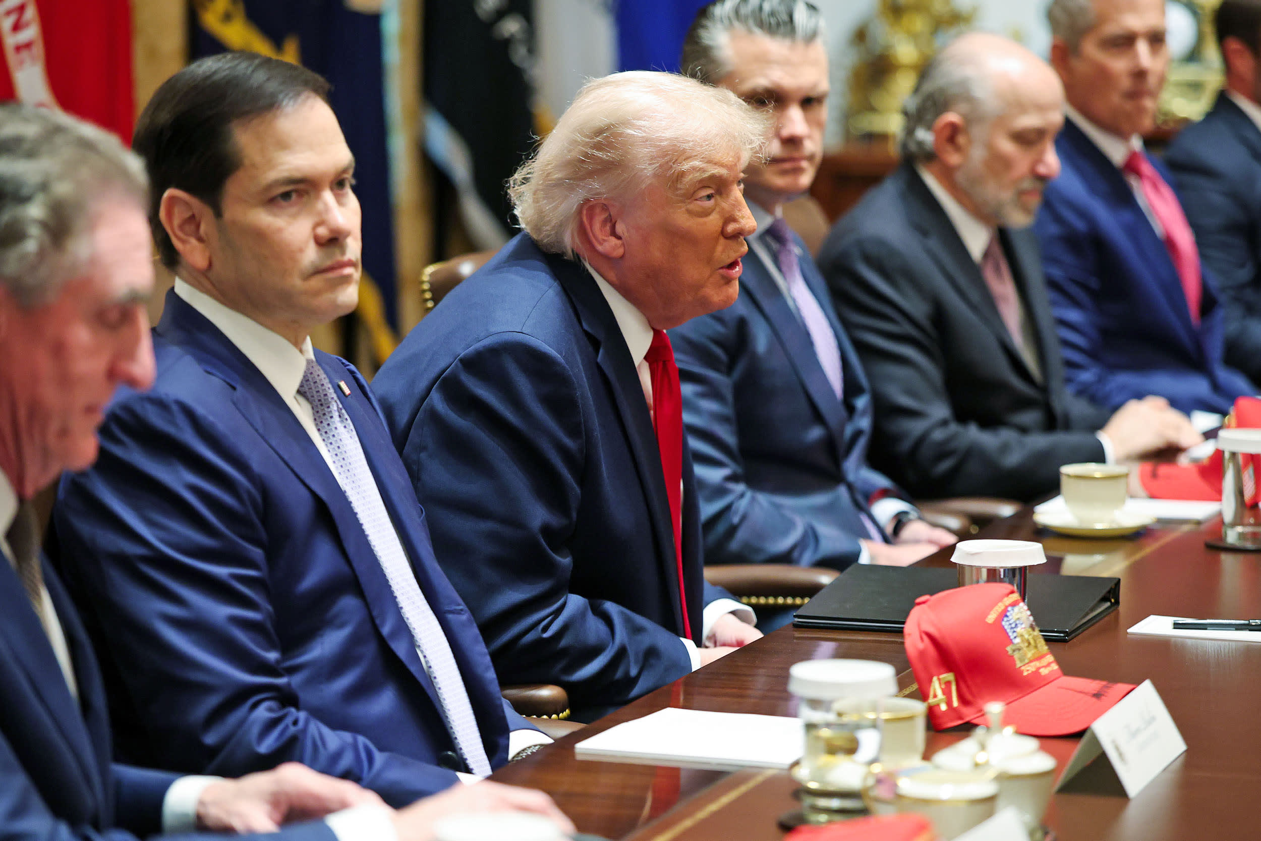 President Donald Trump speaks during a Cabinet meeting at the White House flanked by Marco Rubio and Pete Hegseth