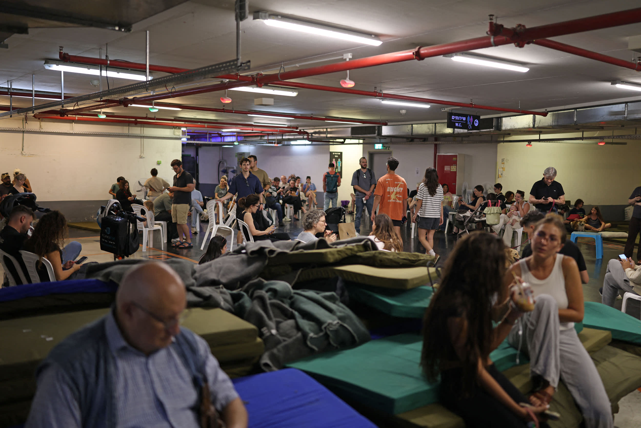 People take cover in a public shelter during a rocket attack alert in Tel Aviv on June 8, 2026.