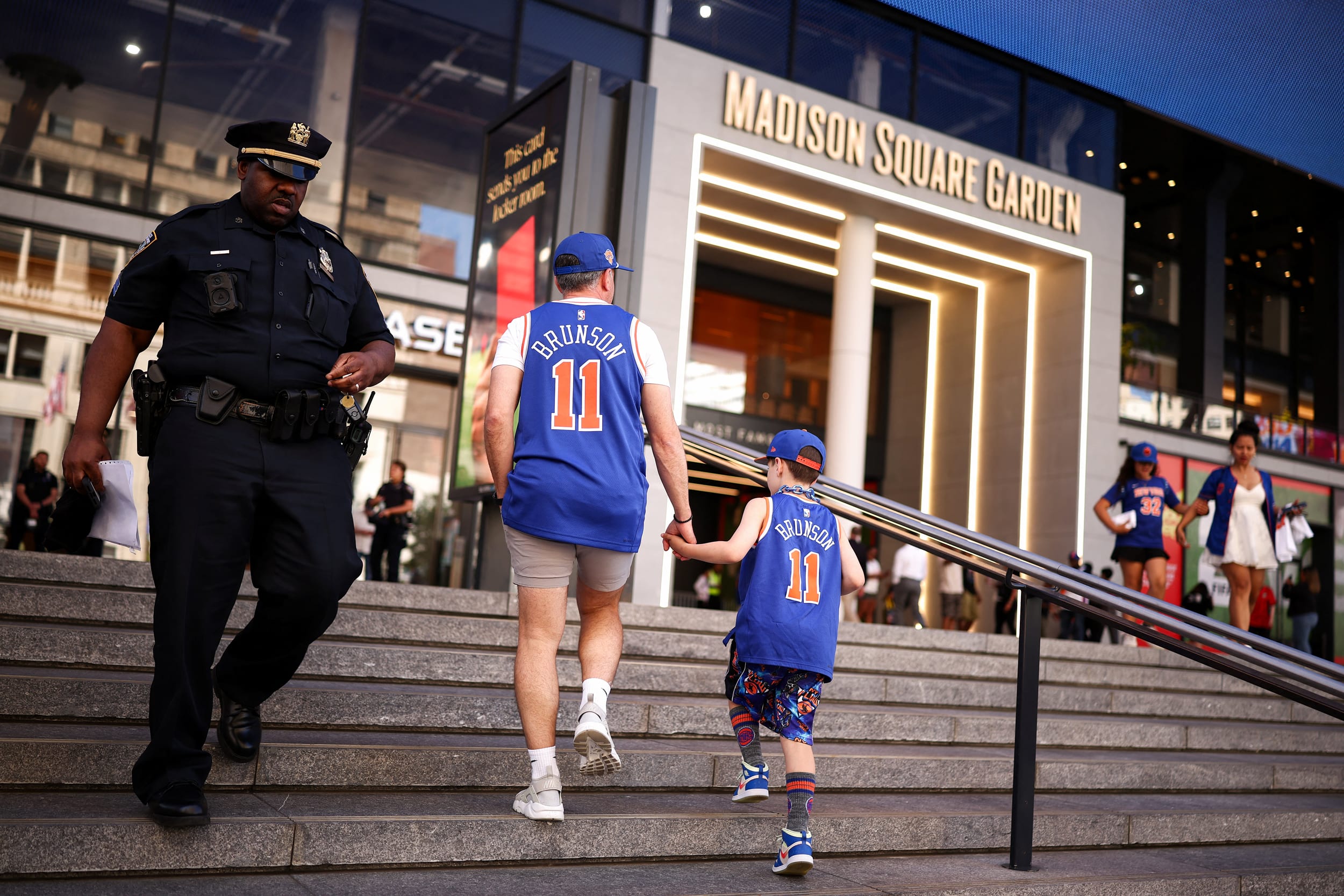 New York Knicks fans and New York Police Department officers gather outside Madison Square Garden.
