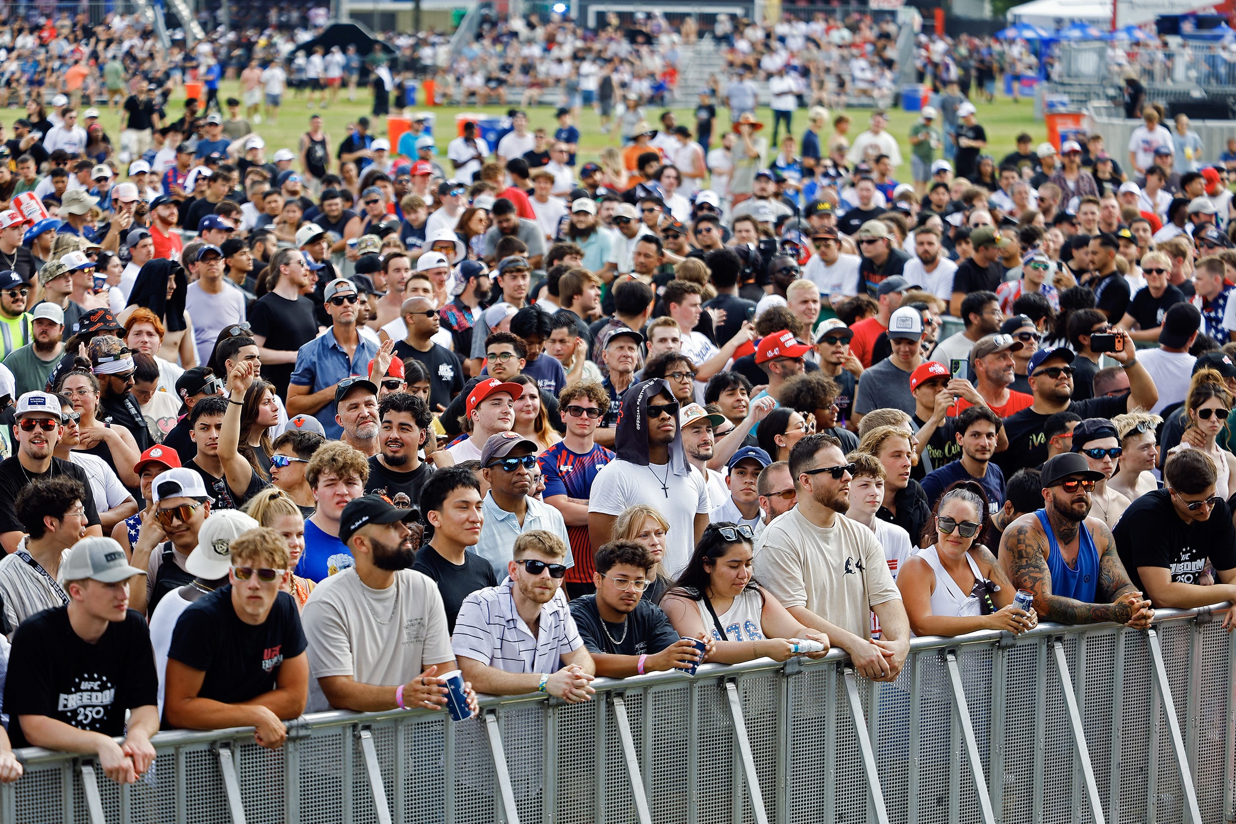 Hundreds of fans at an outdoor sporting event.