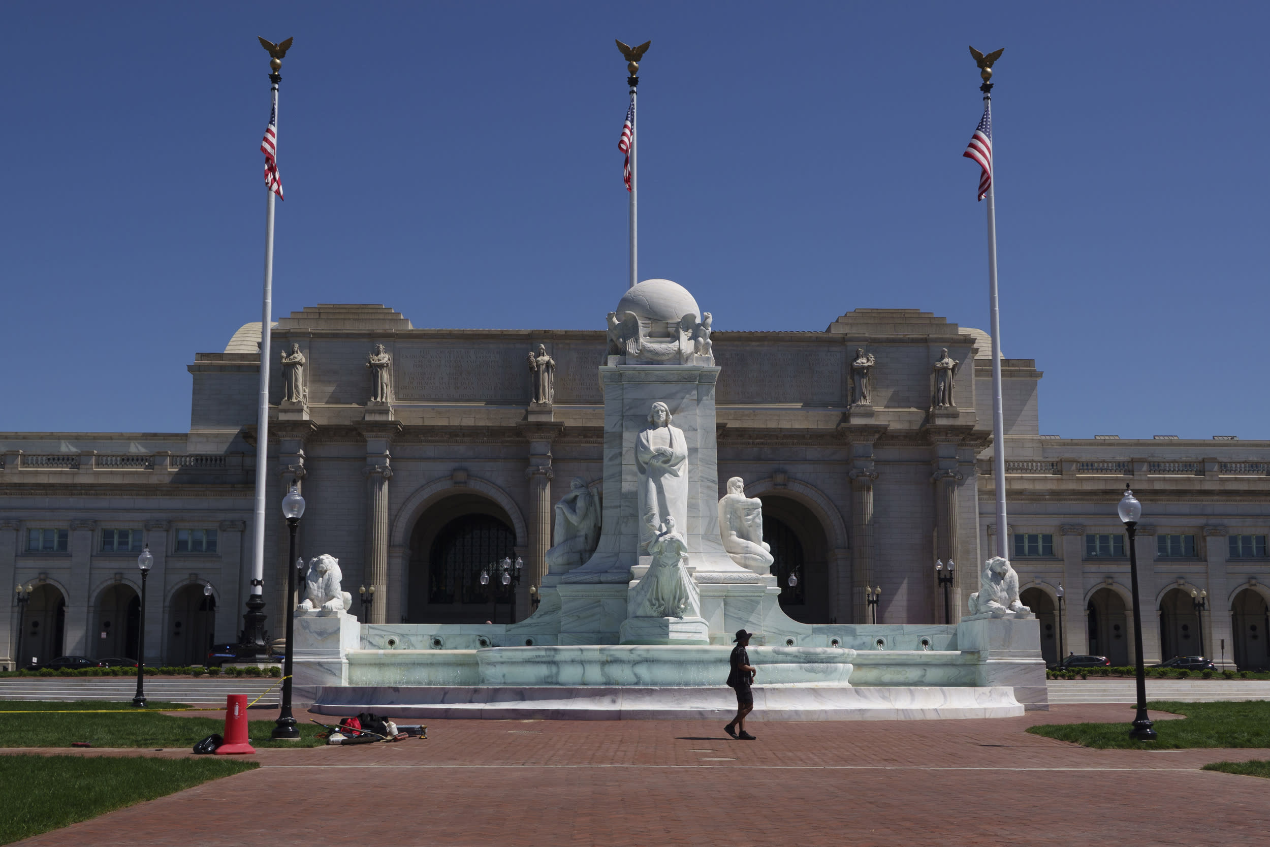 A woman walks by the recently restored Columbus Fountain at Union Station in Washington DC.
