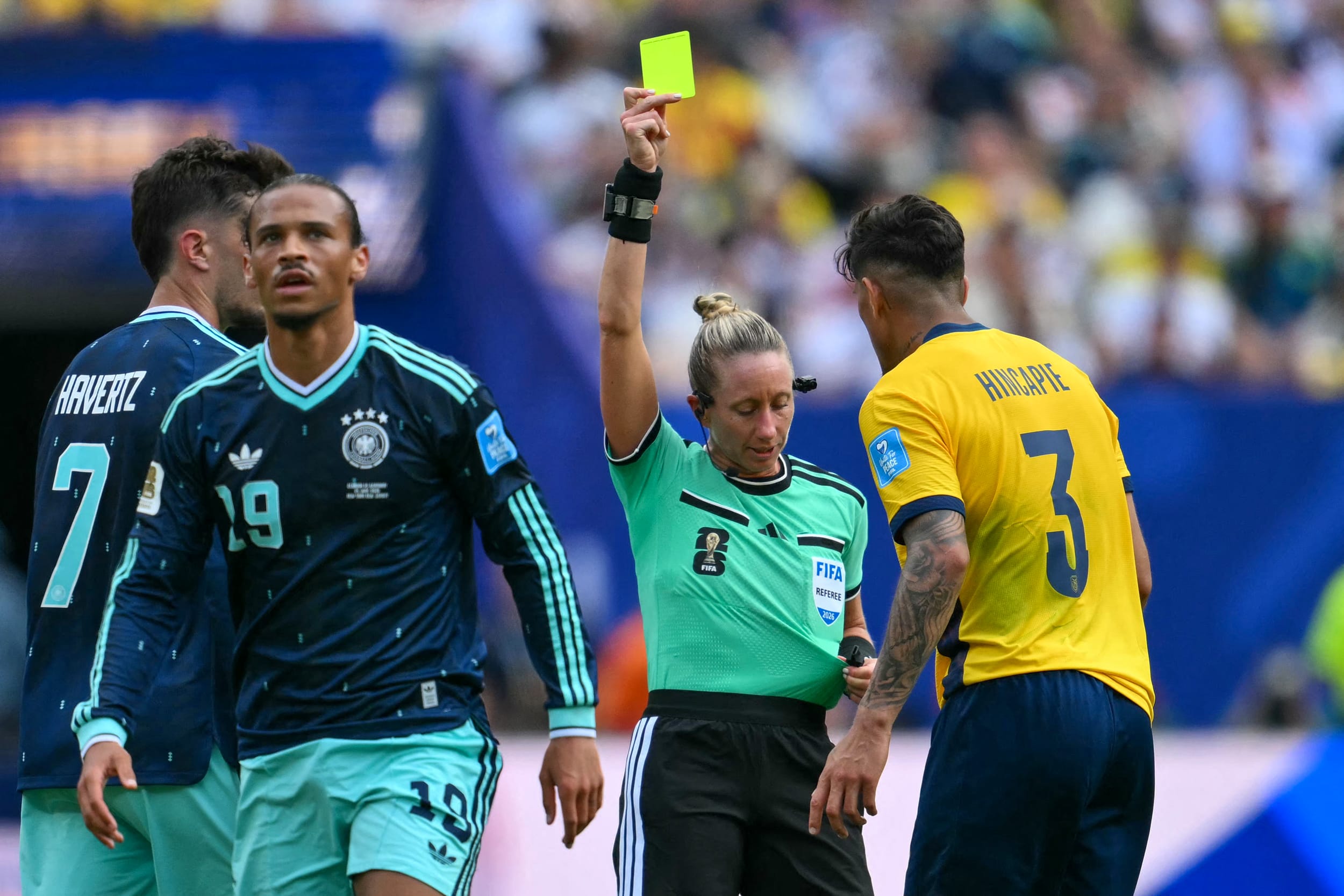 U.S. referee Tori Penso shows a yellow card to Ecuador's defender Piero Hincapie.