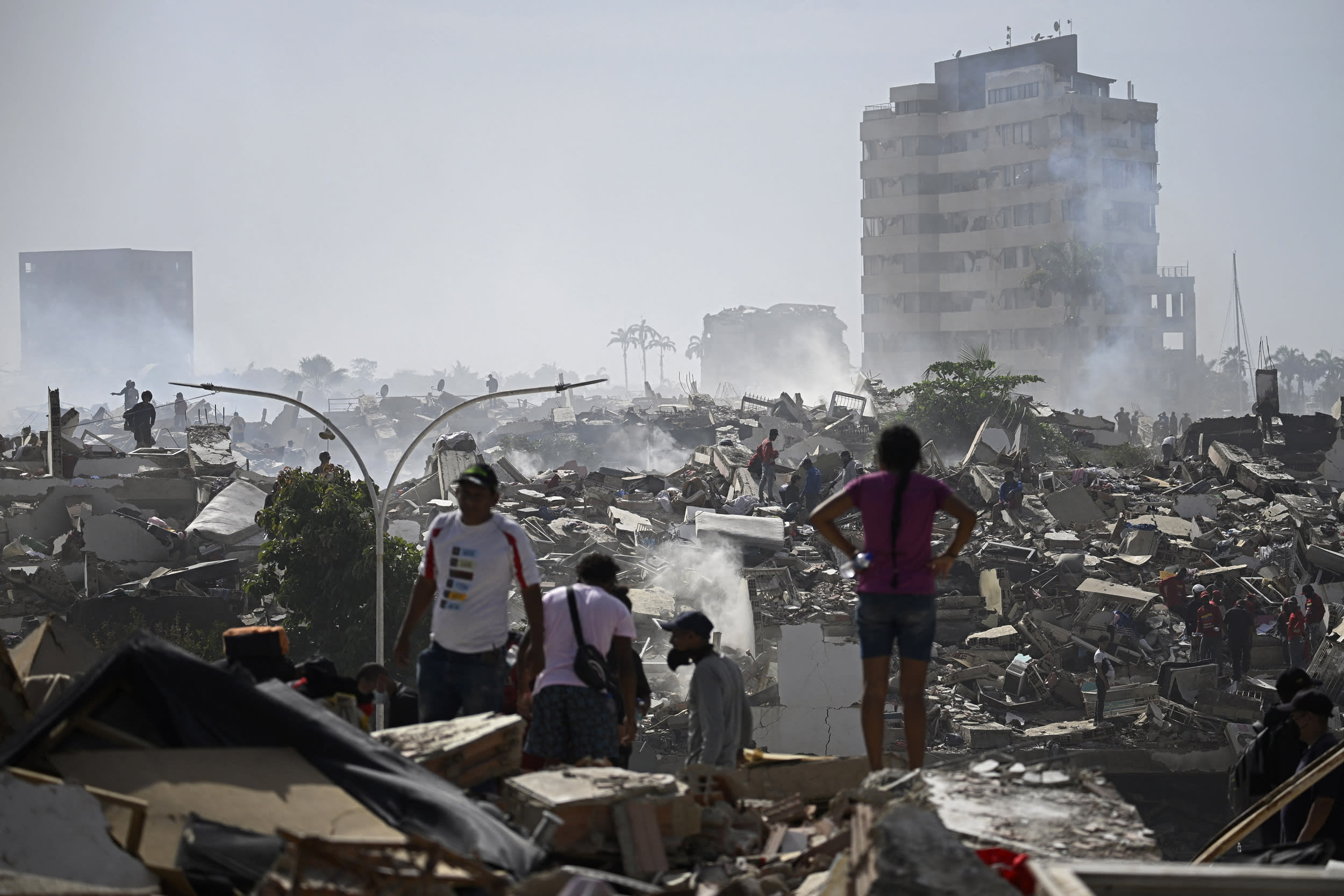 Volunteers search for possible victims in a collapsed building following twin earthquakes in Caraballeda, La Guaira, Venezuela.