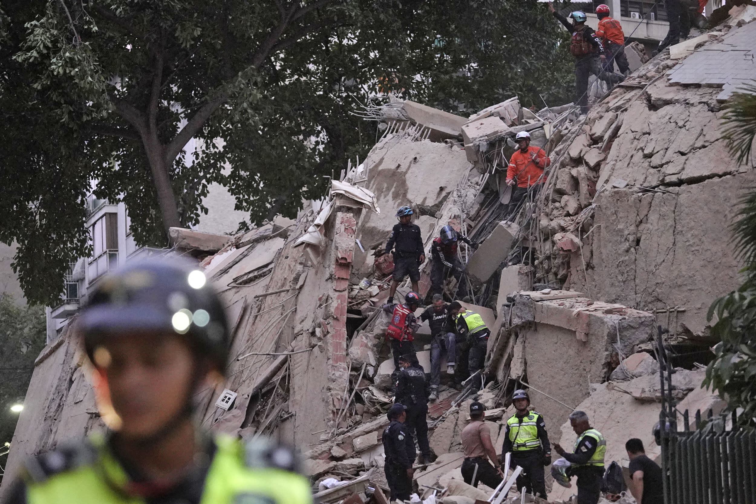 Rescue workers evacuate an injured person from a collapsed building following an earthquake in Caracas on June 24, 2026. 