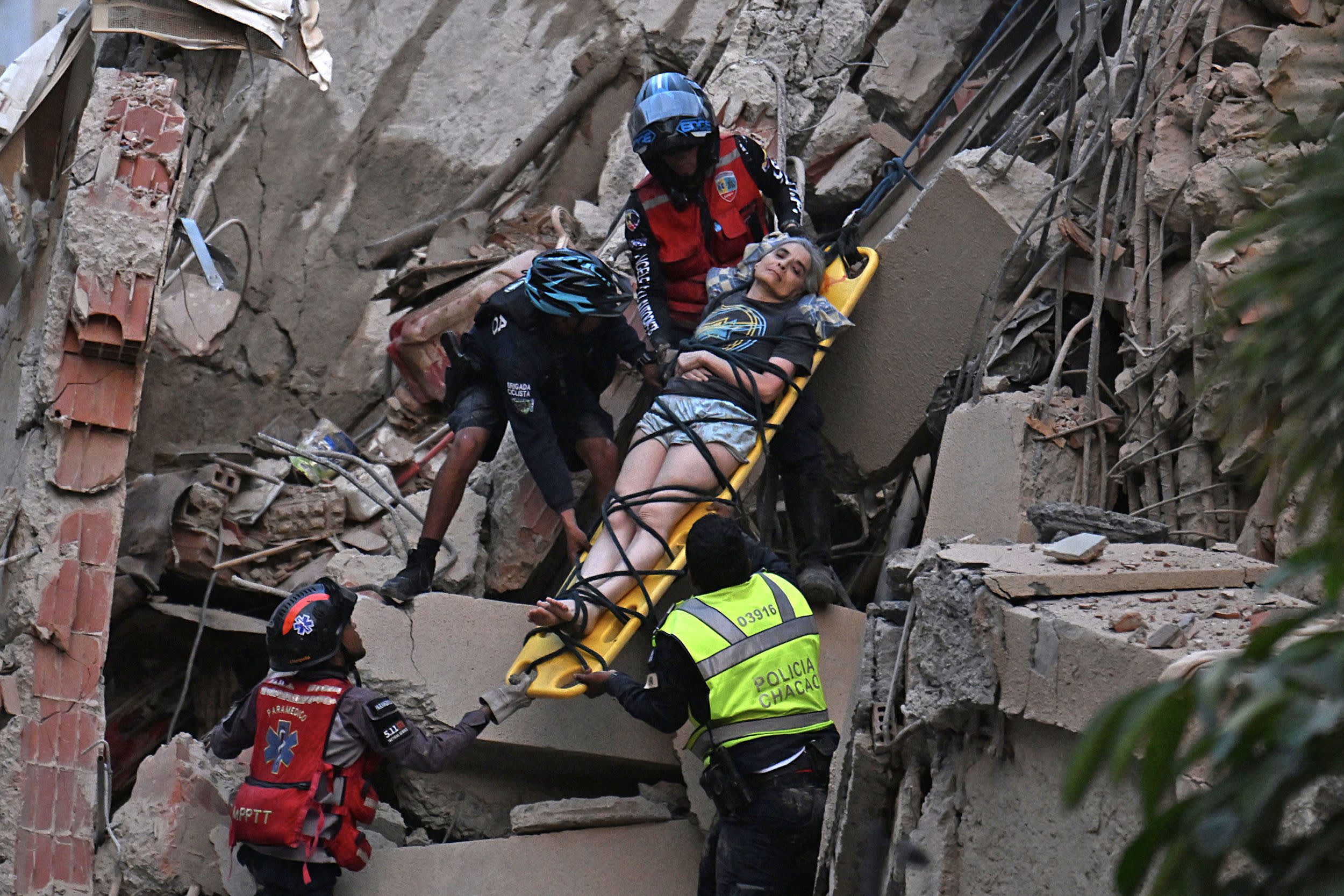 escue workers carry a person on a stretcher out of a collapsed building following an earthquake in Caracas on June 24, 2026.