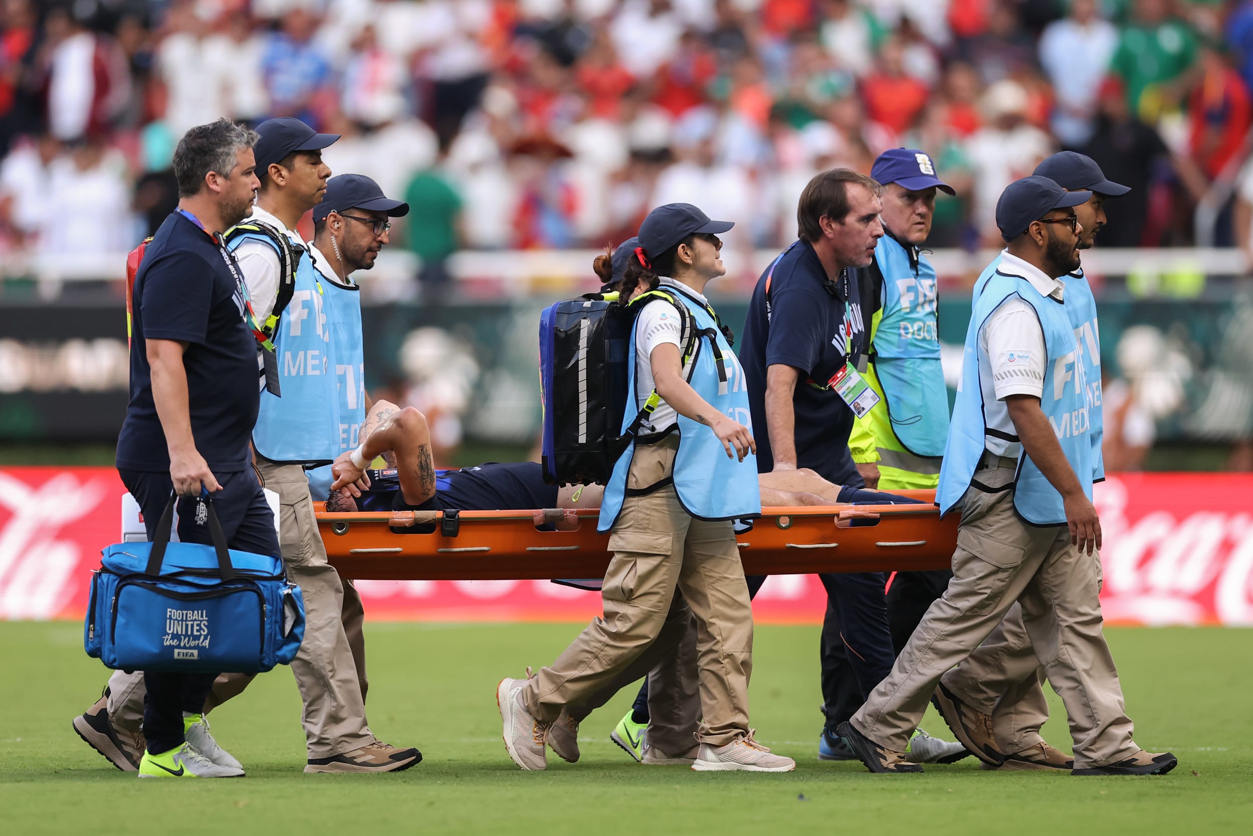 Manuel Ugarte #5 of Uruguay is stretched off after an injury during the Uruguay v Spain match.