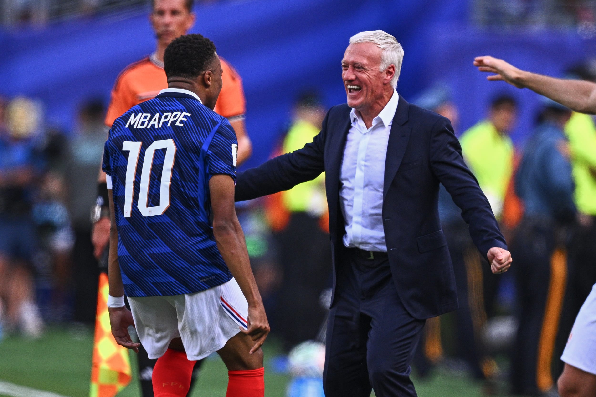 Kylian Mbappé celebrates his goal to make it 1–0 during France vs. Sweden with coach Didier Deschamps.