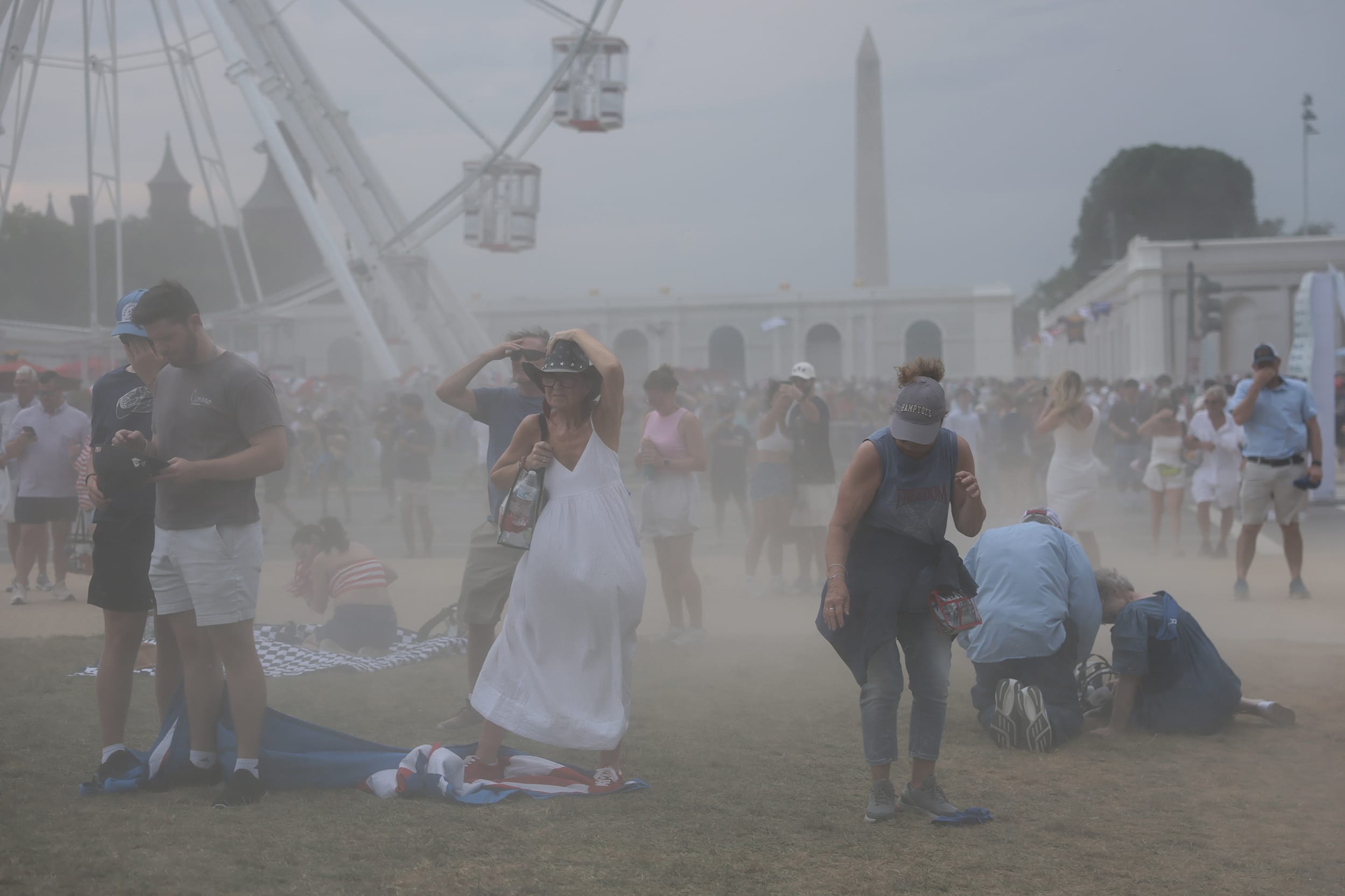 Dust blowing into the air through a crowd of people on the National Mall.