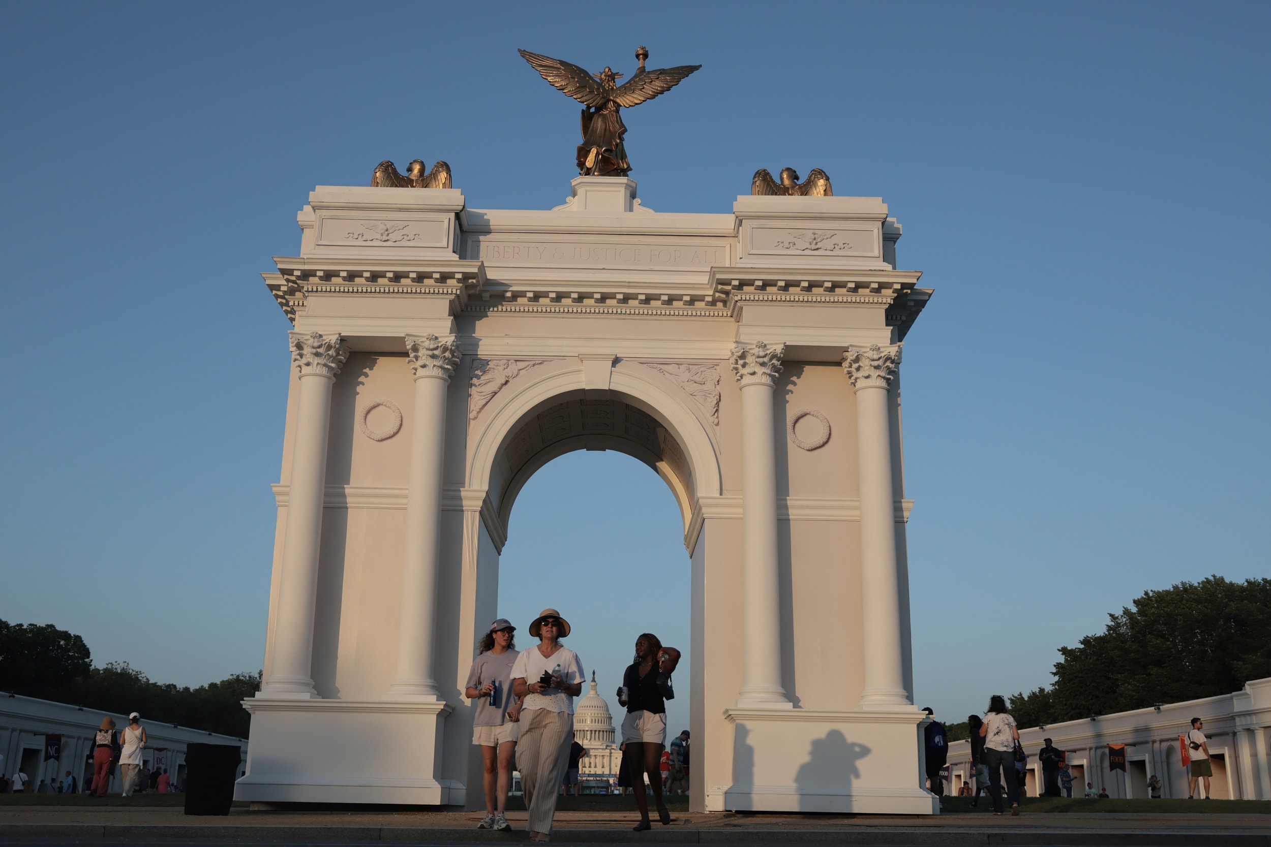 Visitors walk near a replica of President Trump's planned "Triumphal Arch" in Washington D.C.