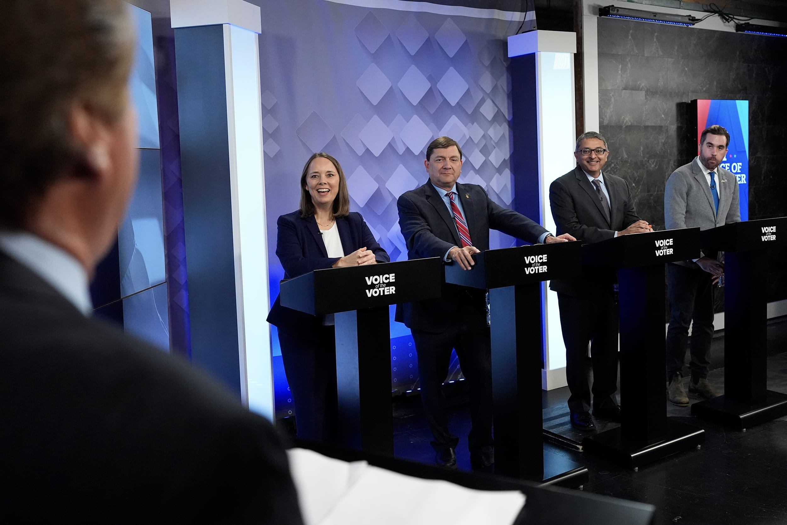 Jordan Wood,Dr. Nirav Shah,Troy Jackson,Shenna Bellows standing at a row of podiums.