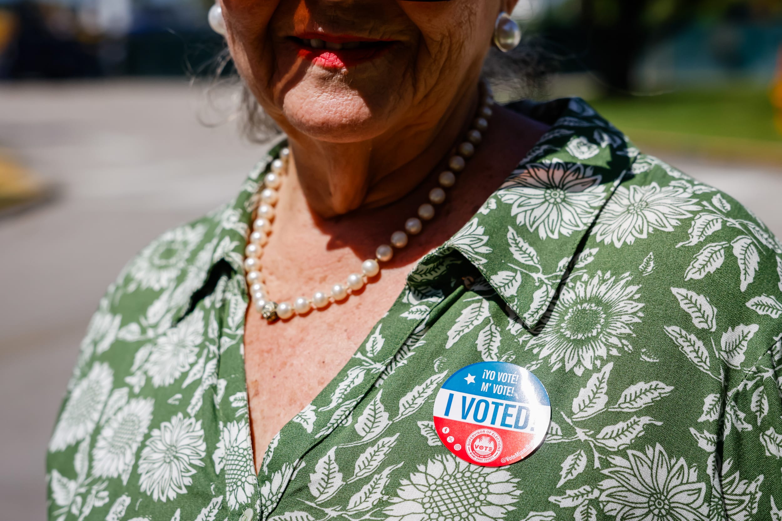 A voter wears an "I Voted" sticker .