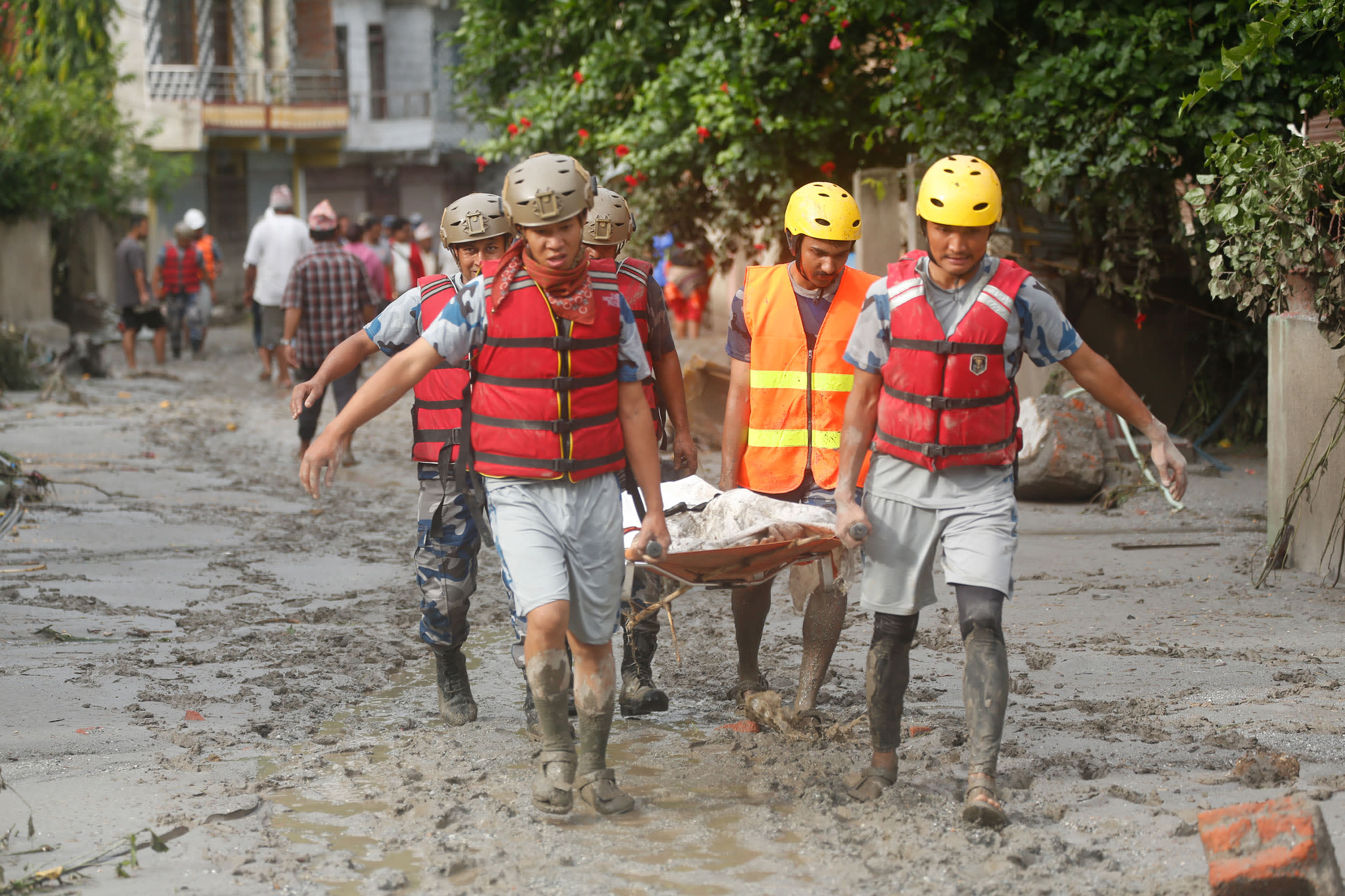 Rescue teams collect a body on Thursday, Aug. 27, 2026, in Nuwakot, central Nepal.