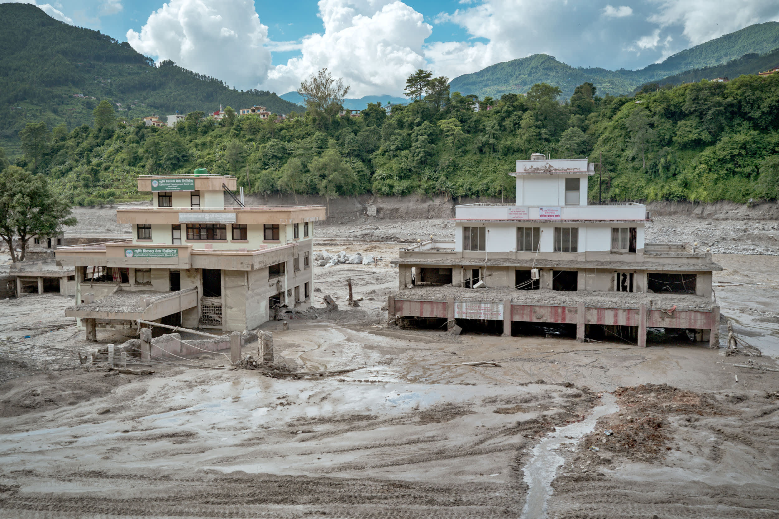 Buildings covered in heavy mud following flash floods on August 27, 2026 in Trishuli, Nepal.
