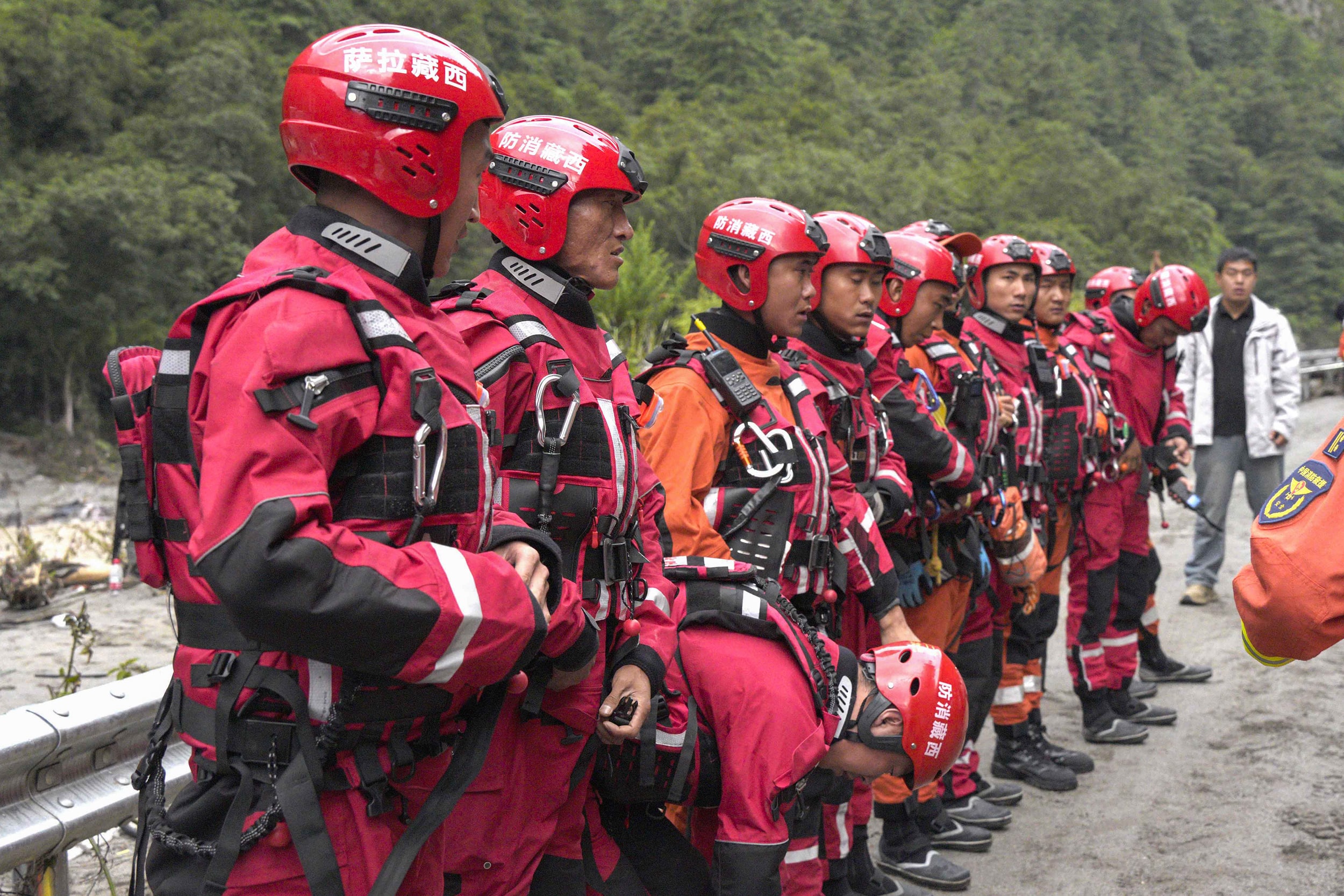 Rescue workers gather in line.