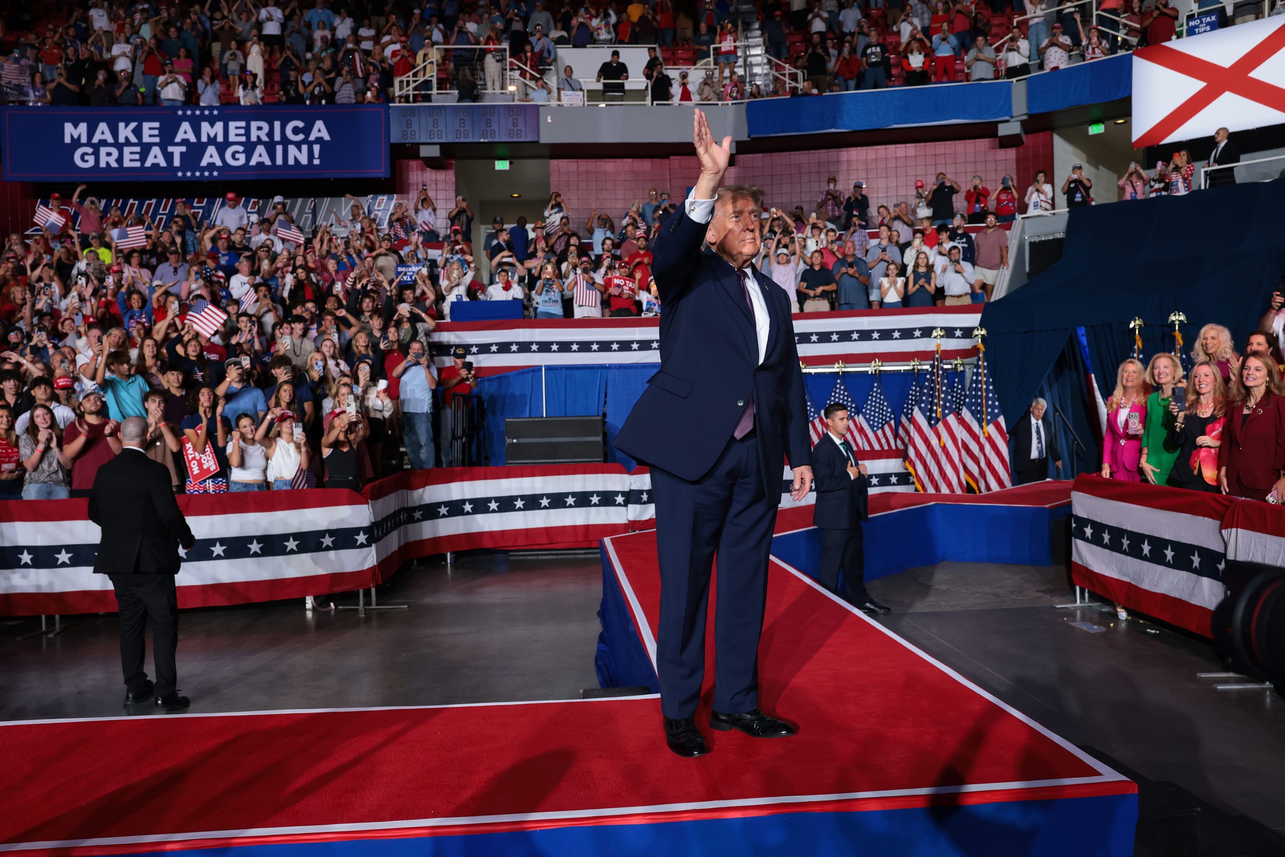 U.S. President Donald Trump walks off the stage.