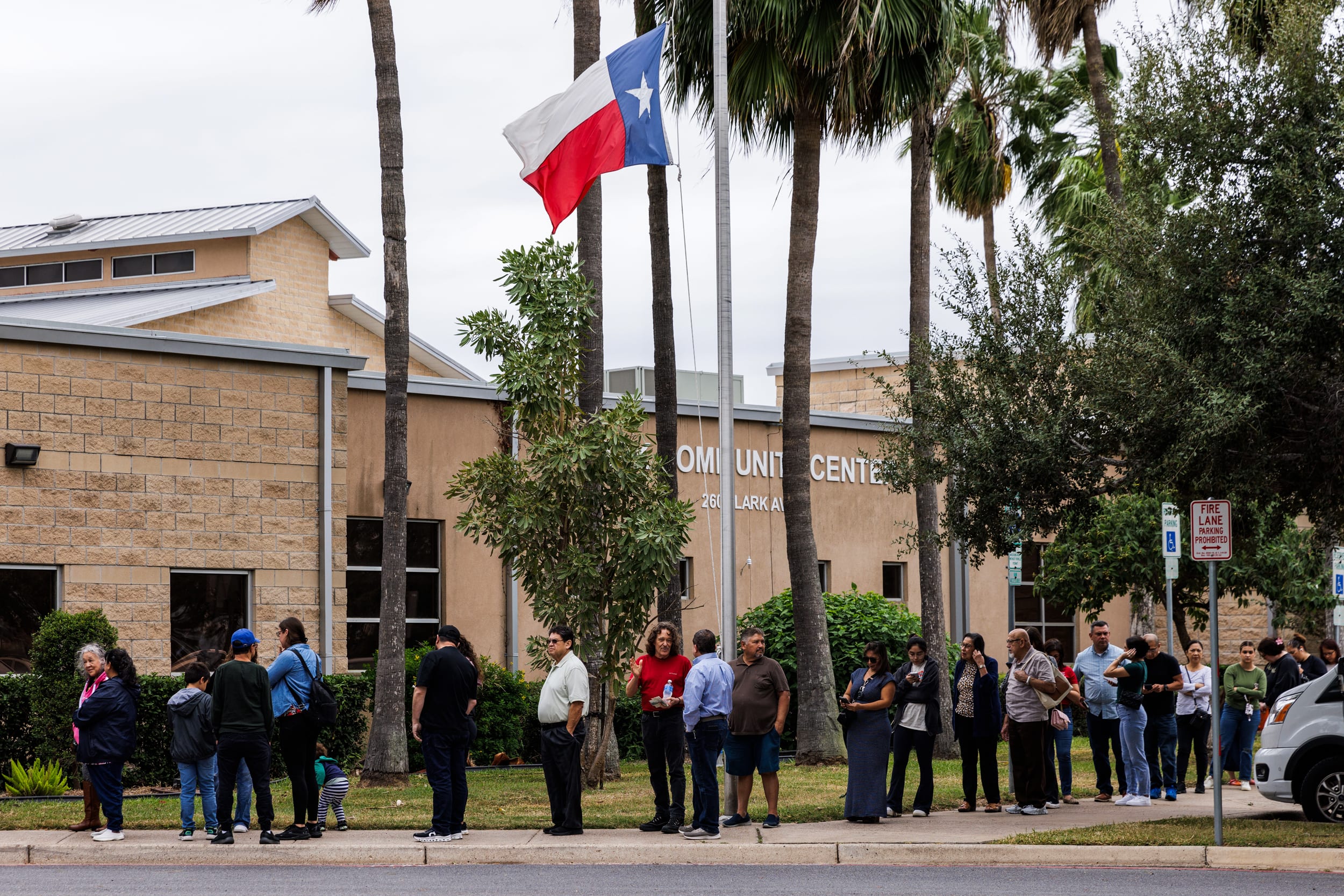 Voters wait outside of a polling place.
