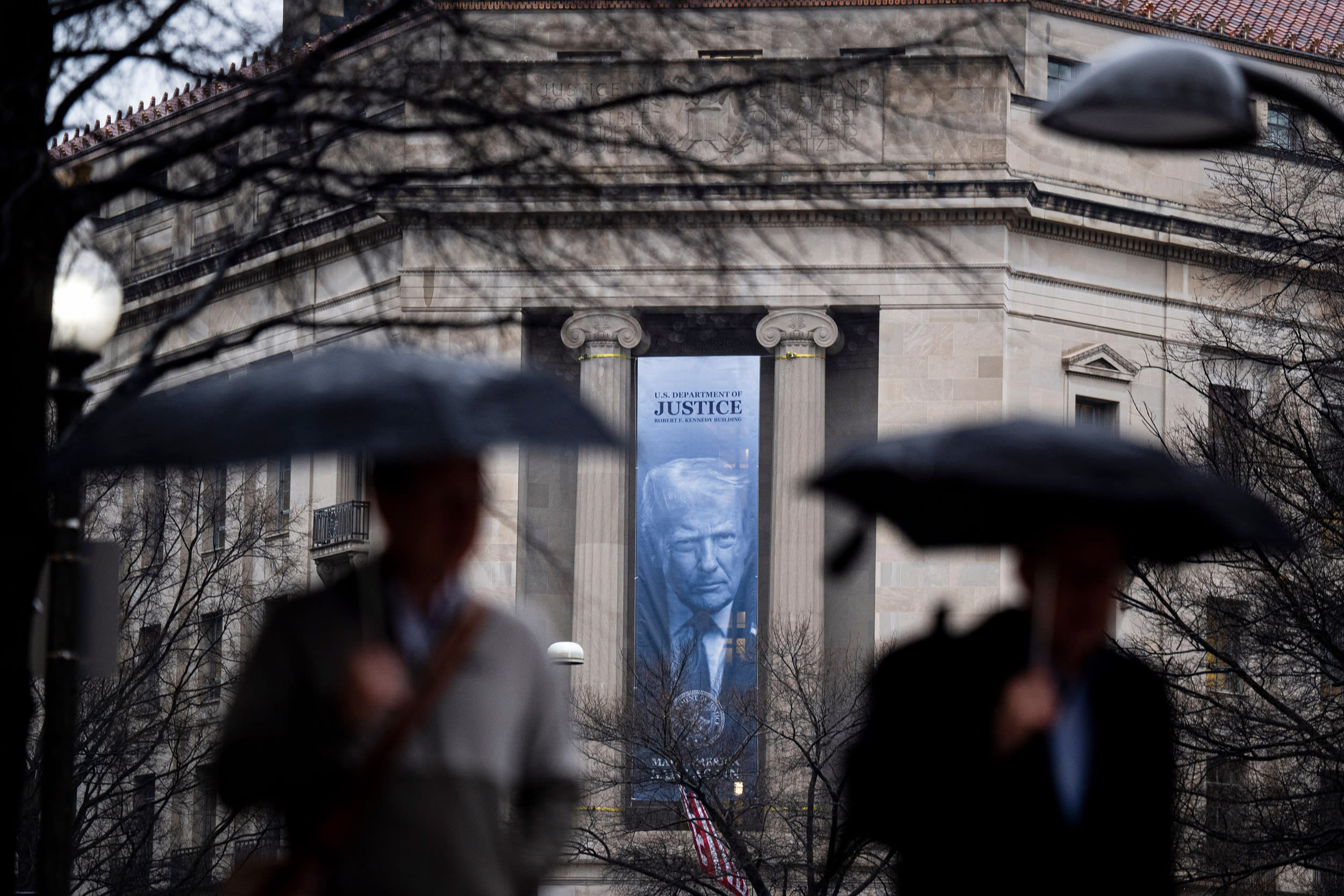 A banner of President Trump outside of the Department of Justice.