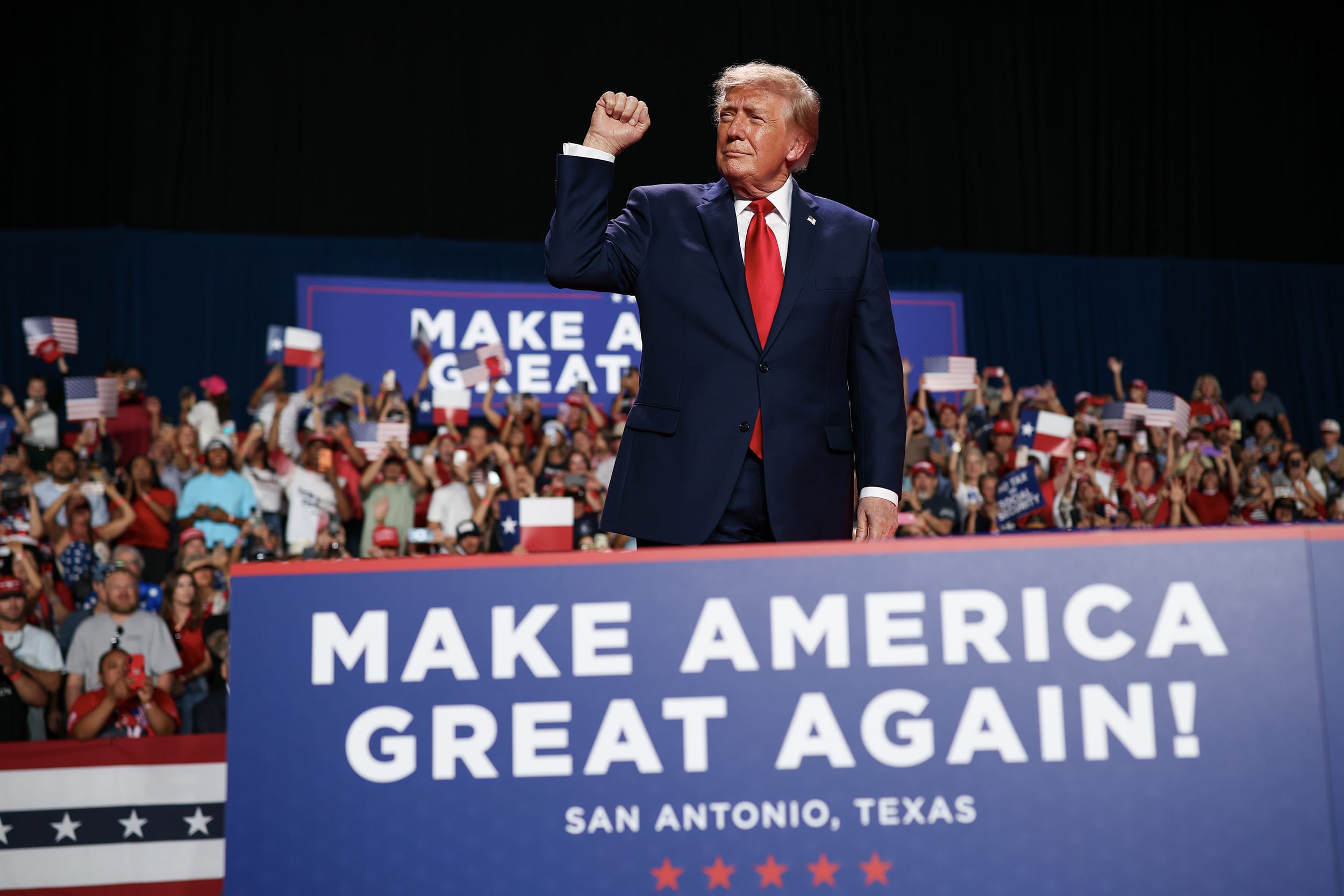 President Trump on stage during an indoor rally.