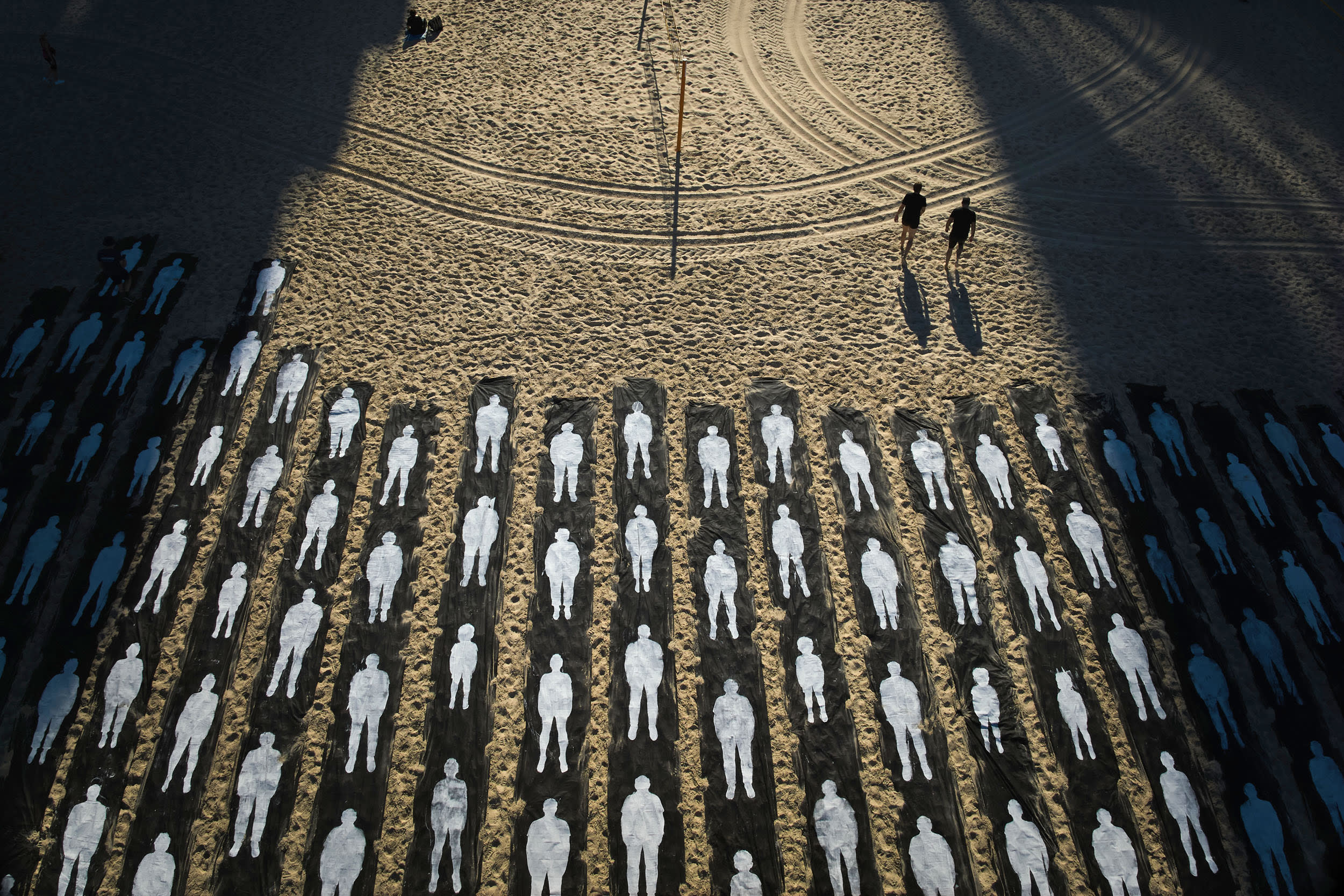 People walk past an installation marking the third anniversary of the Oct. 7, 2023, Hamas attack on Israel, on the beachfront in Tel Aviv, Israel, Wednesday, Oct. 7, 2026.