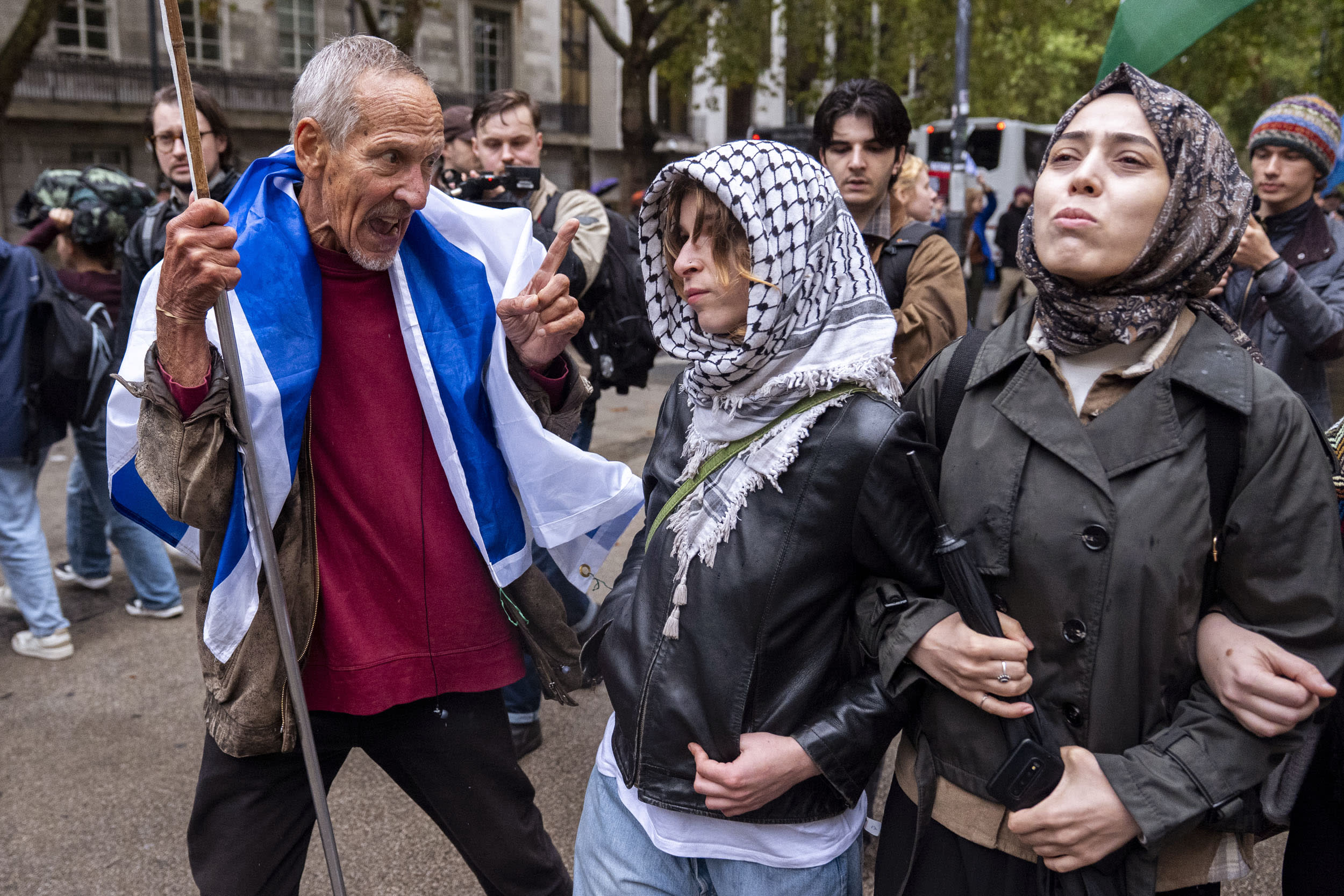 A pro-Israel counter-protester speaks to students marching in support of Palestine on Oct. 7, 2026.