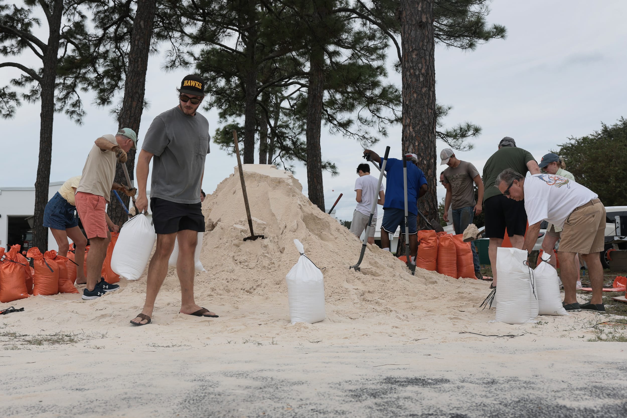 People appear to prepare sandbags for a possible storm.