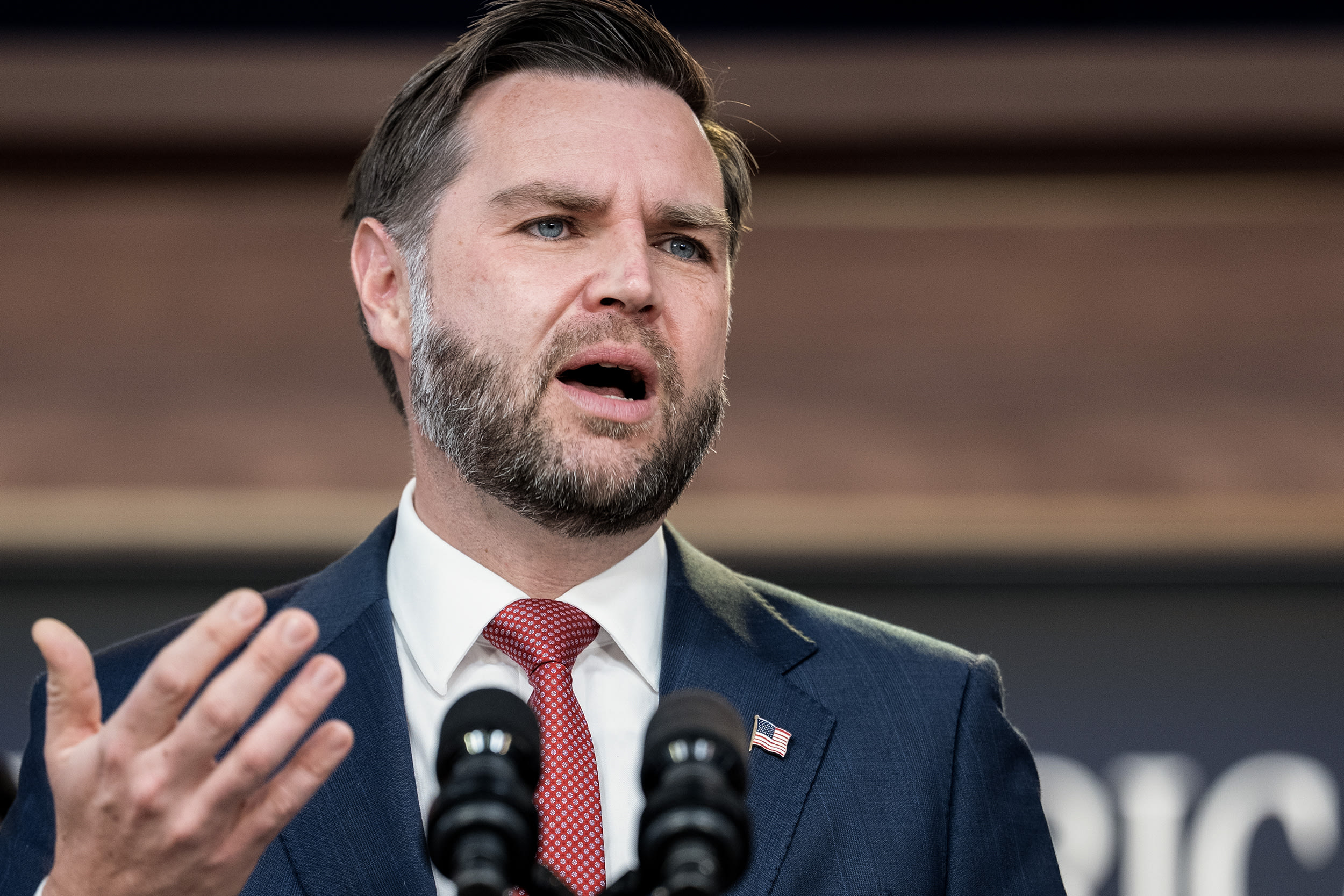 JD Vance speaking at a podium.