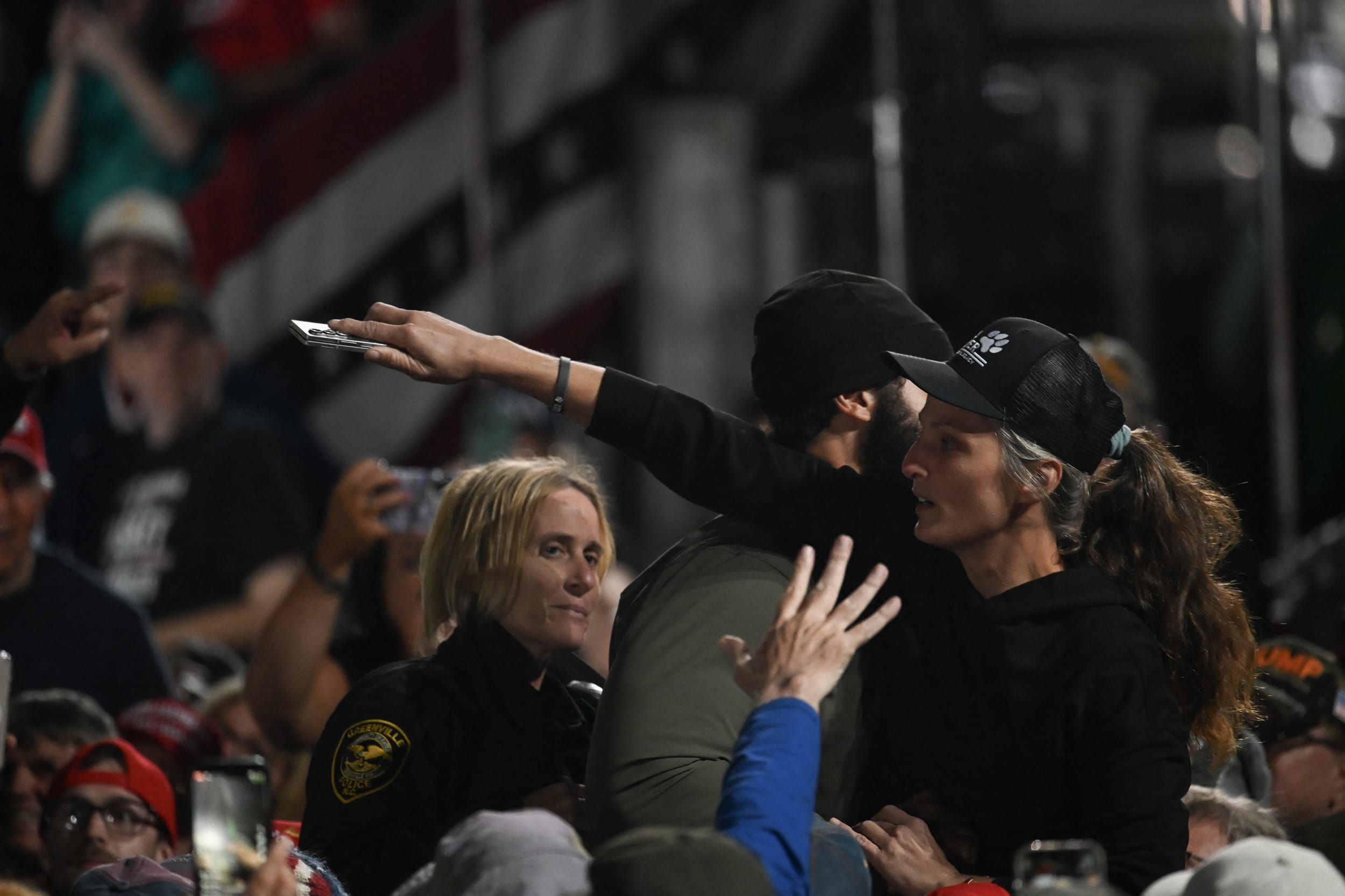 Security officers escort out a protestor from a rally.