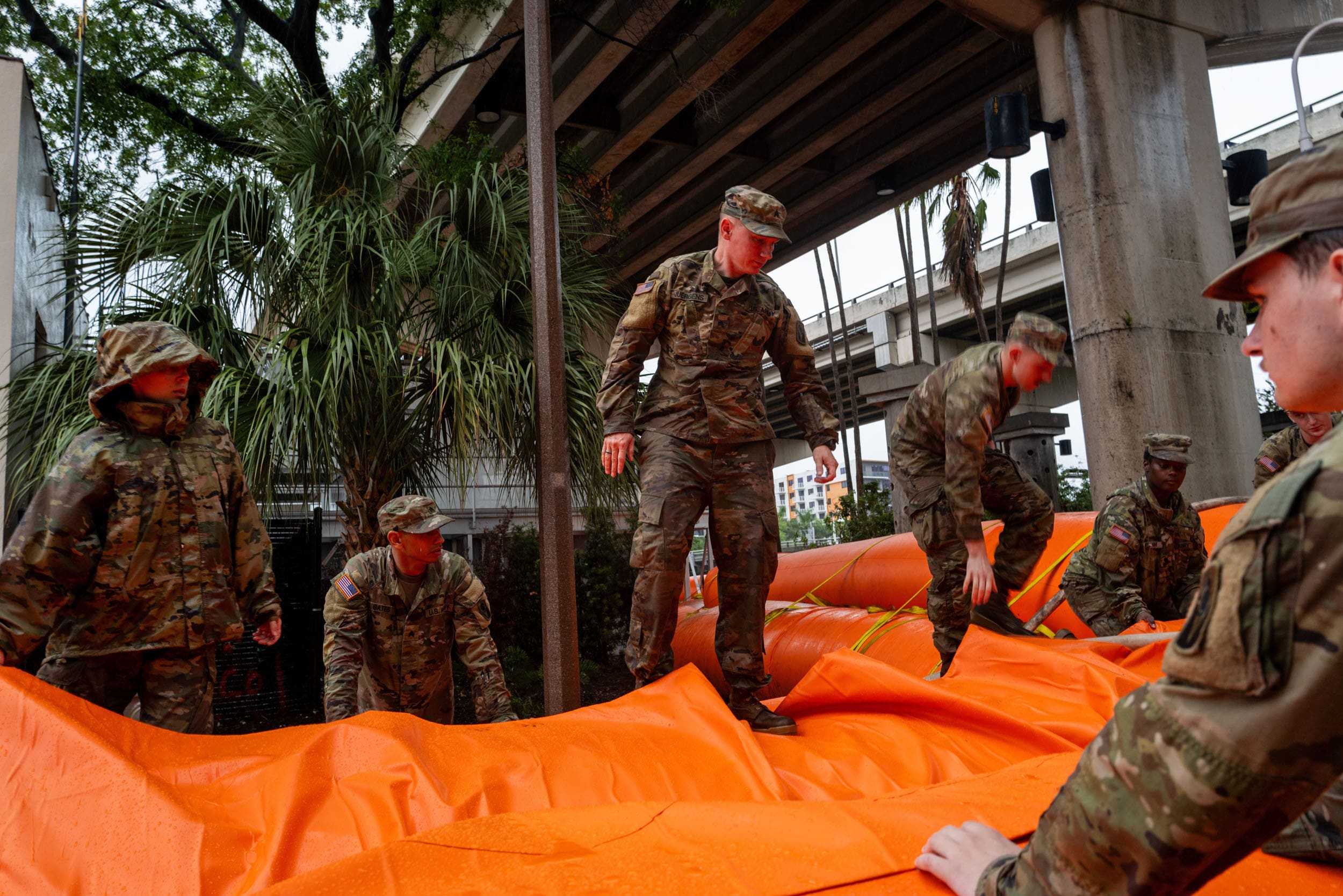 National Guard members put up a flood barrier around a waste water facility on Oct. 9, 2024 in Tampa, Fla.