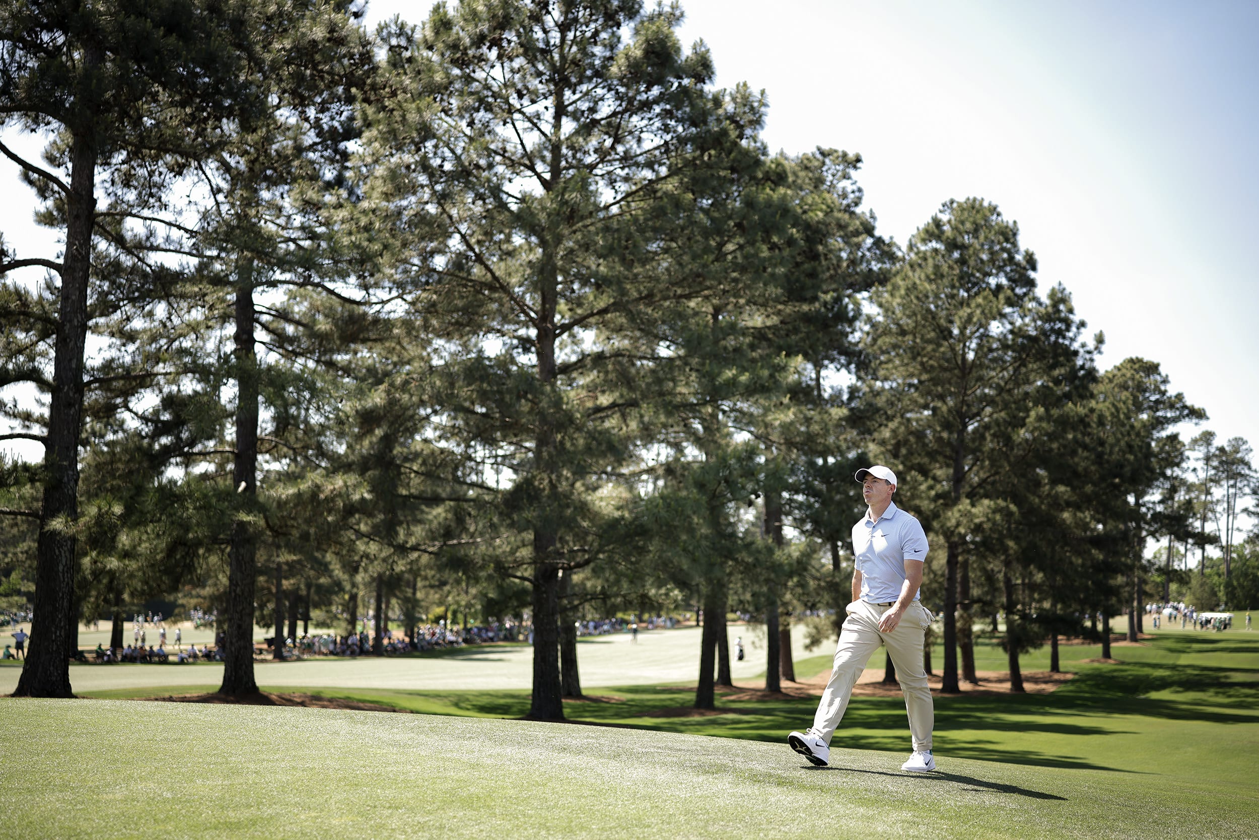 Rory McIlroy walking on a golf course.