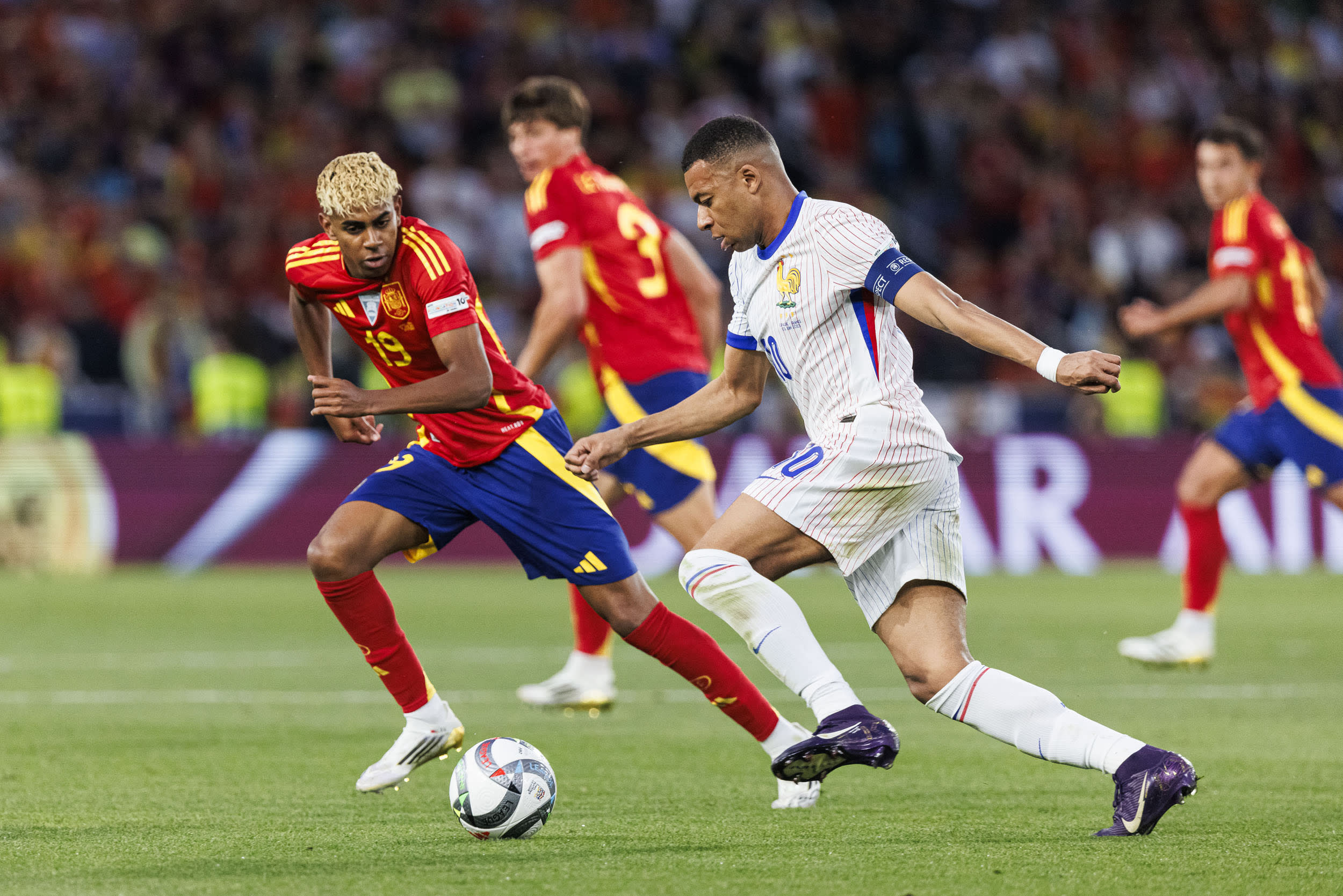 Kylian Mbappé of France is challenged by Lamine Yamal of Spain