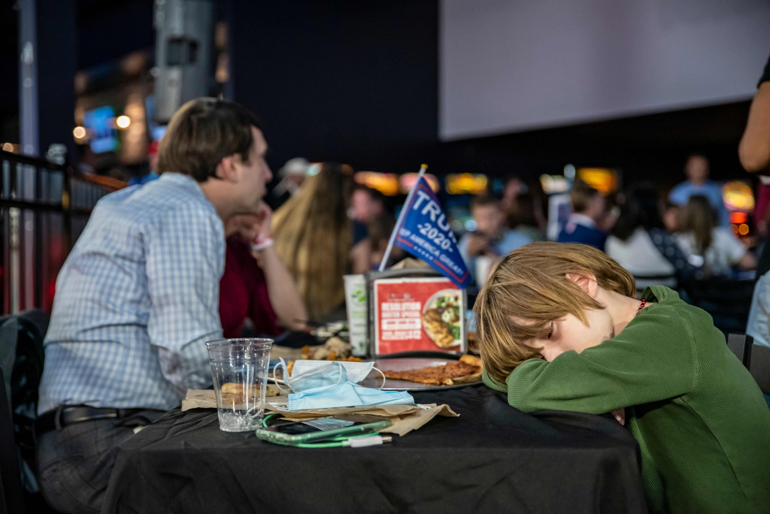 A boy sleeps at the table at a watch party for Republicans on election day in Austin, Texas.