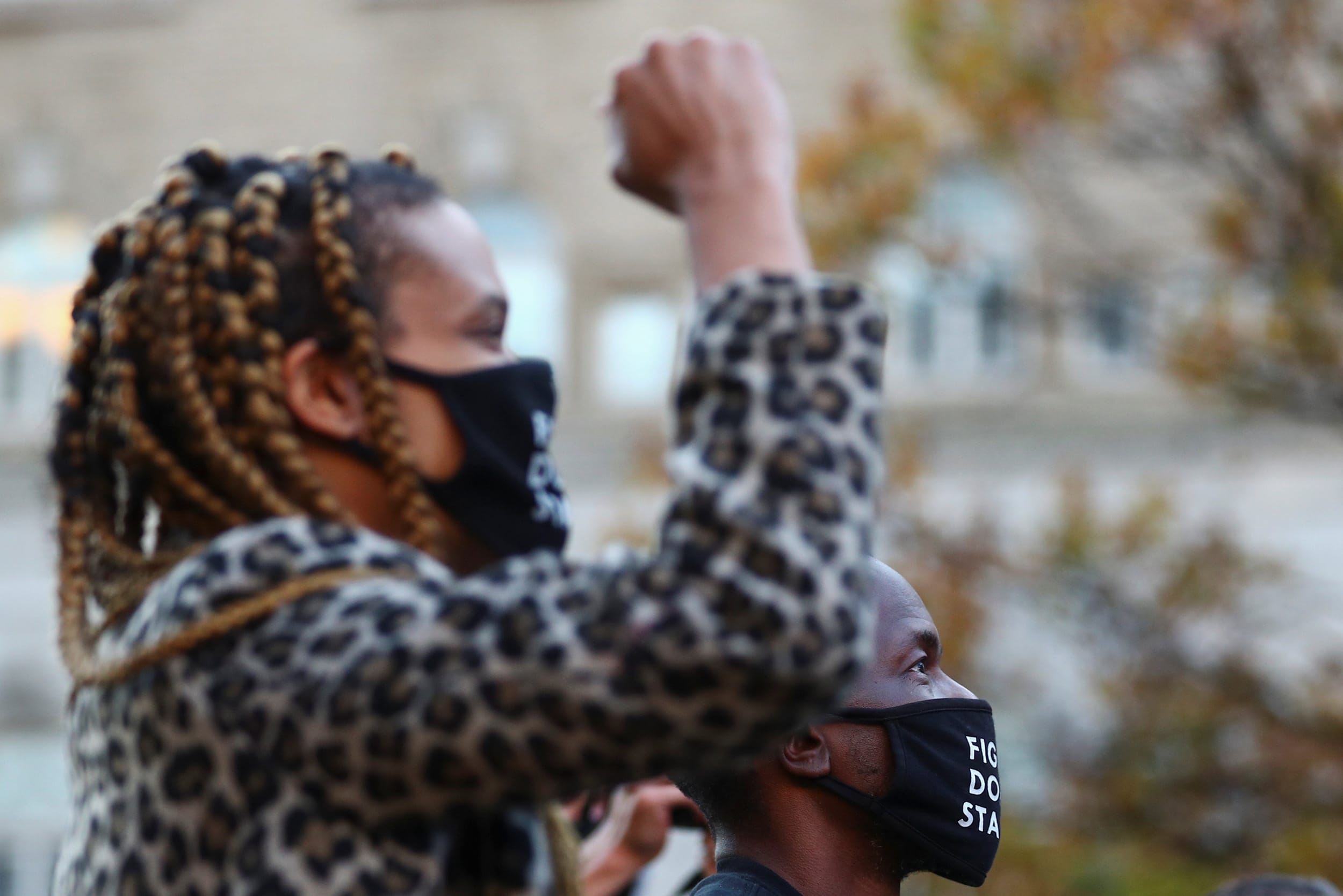 Image: People react while watching news of Democratic U.S. presidential nominee and former Vice President Joe Biden winning Michigan broadcasted on a television, after Election Day in Washington