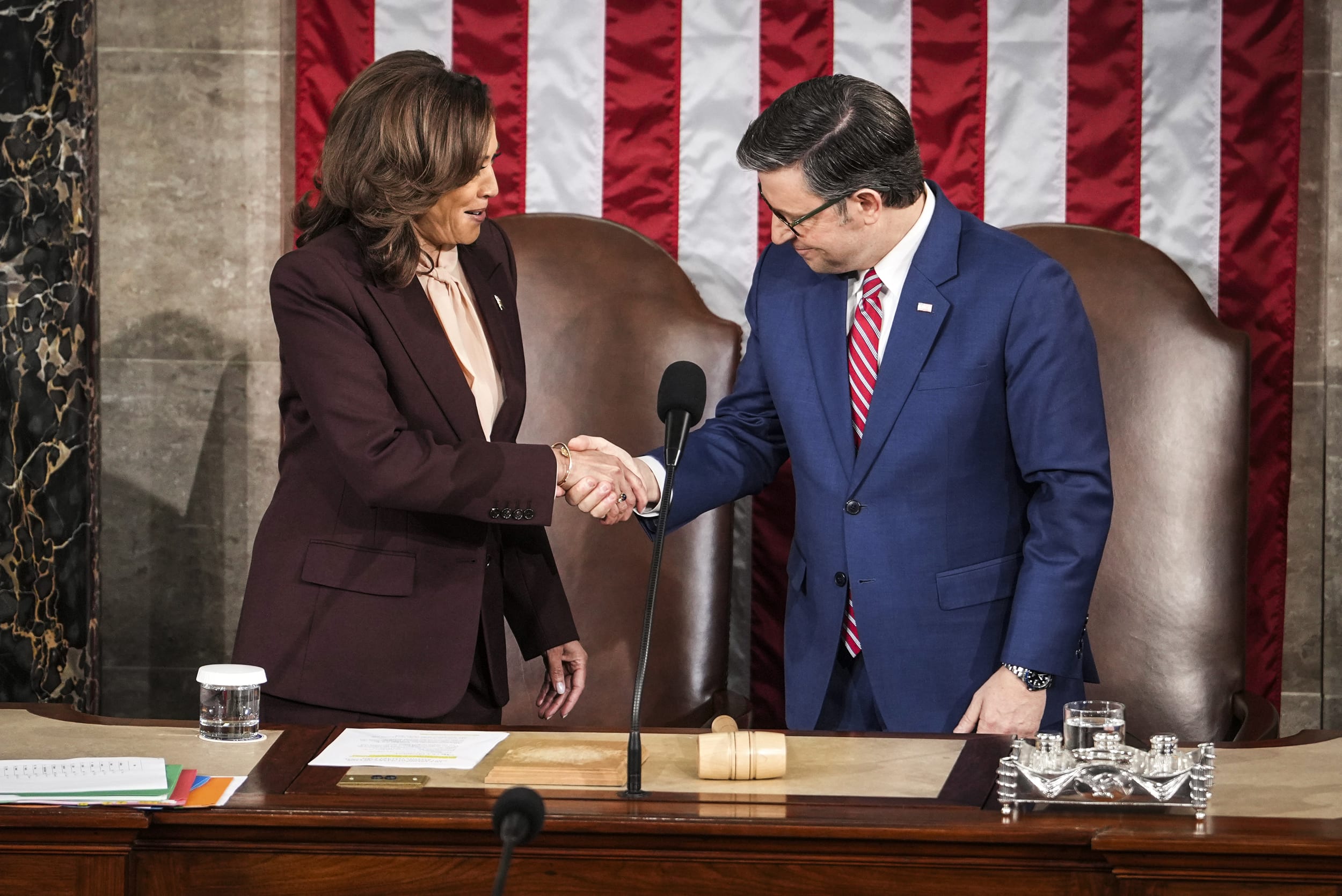 Vice President Kamala Harris shakes hands with House Speaker Mike Johnson of La.,