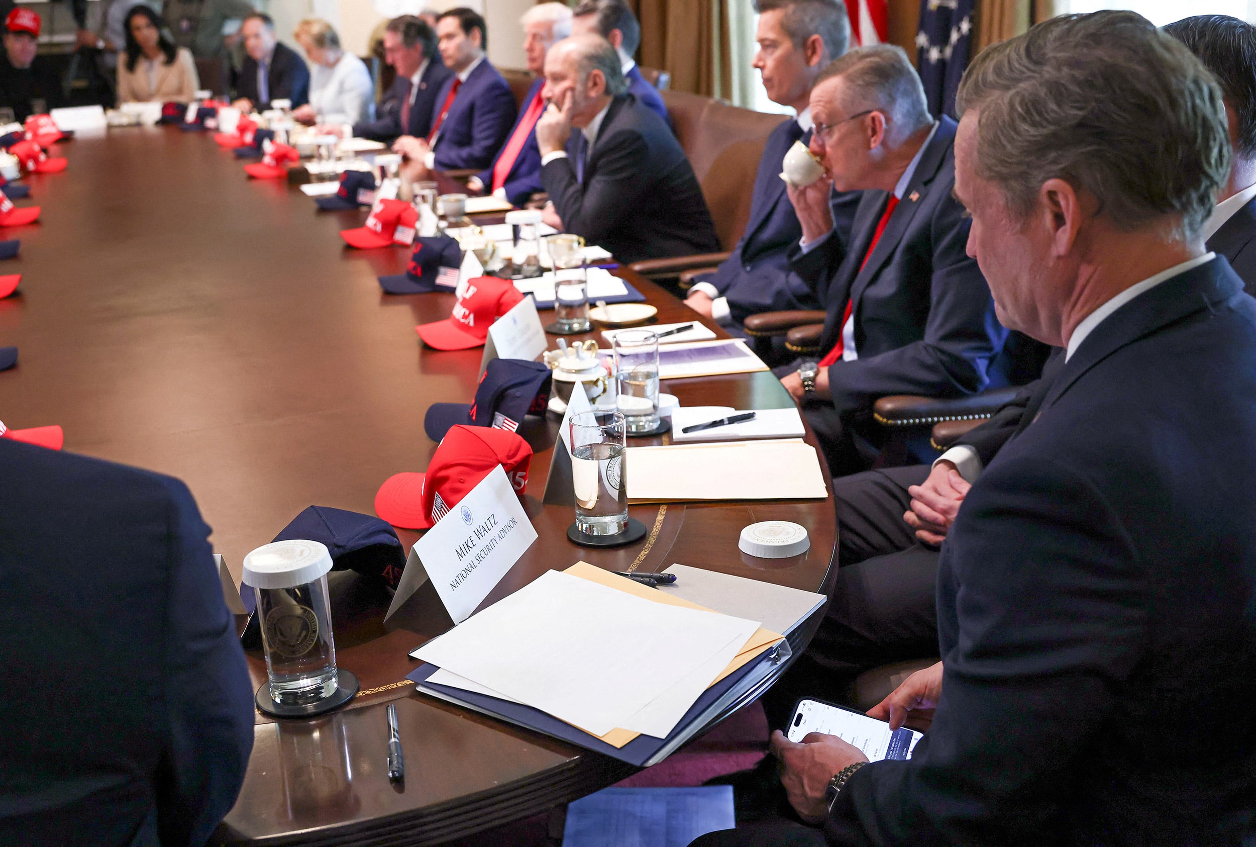 Mike Waltz looking at the Signal app on his phone