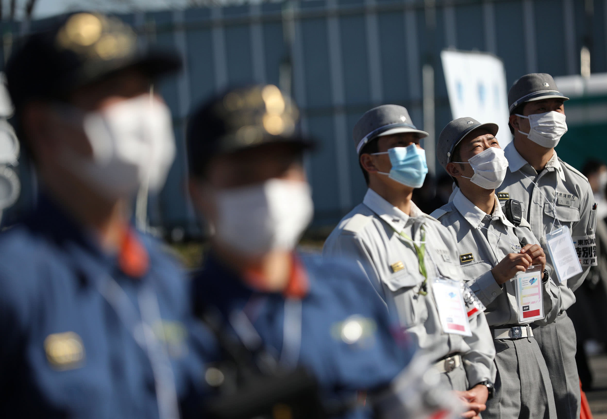 Image: Rescue workers, wearing protective face masks, following an outbreak of the coronavirus, observe a test event for sport climbing at Aomi Urban Sports Park in Tokyo