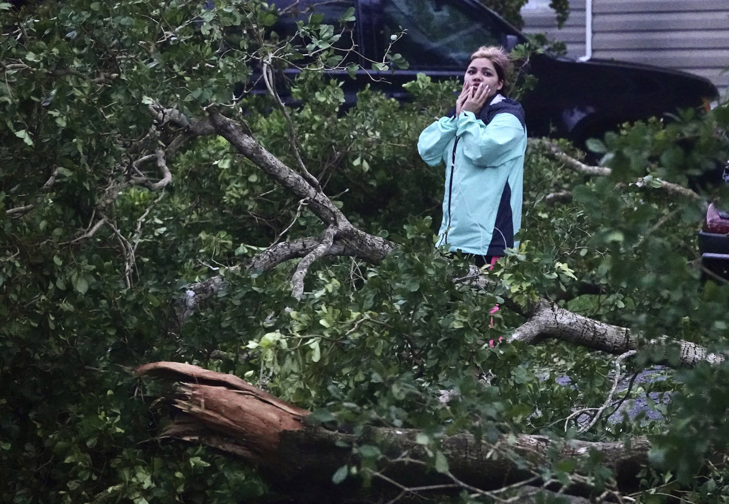 Zuram Rodriguez surveys the damage around her mobile home in Davie, Fla.