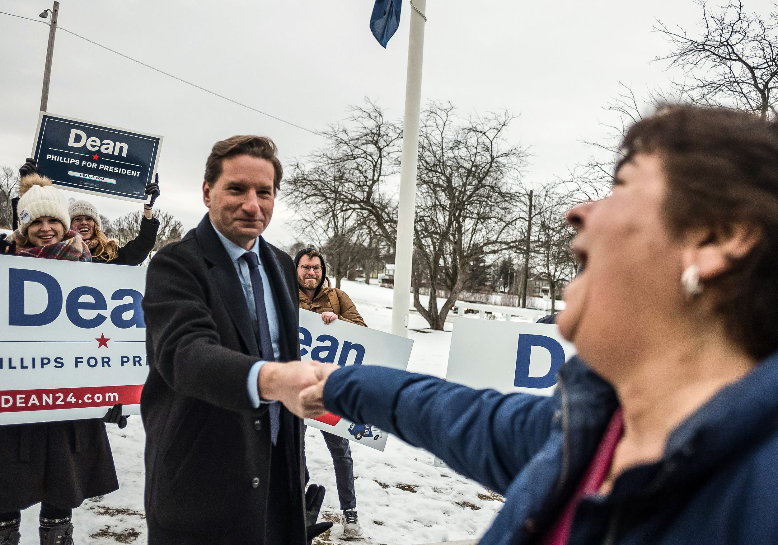 Democratic presidential candidate Dean Phillips greets a person outside a Manchester middle school on New Hampshire’s primary day